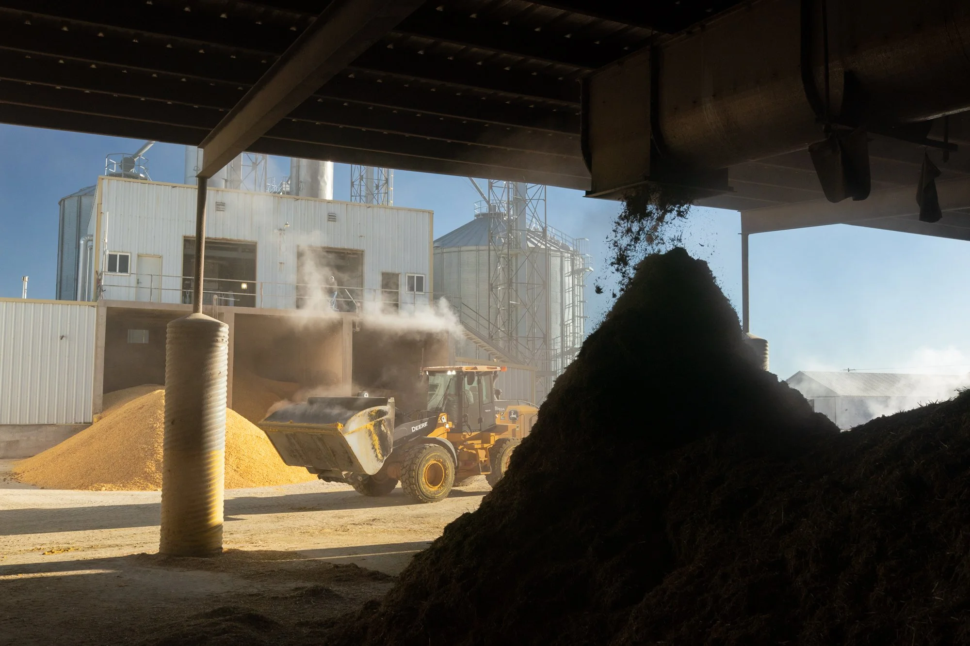 Wheel loader moves feed ingredients beneath the feed mill at Magnum Feedyard in Colorado