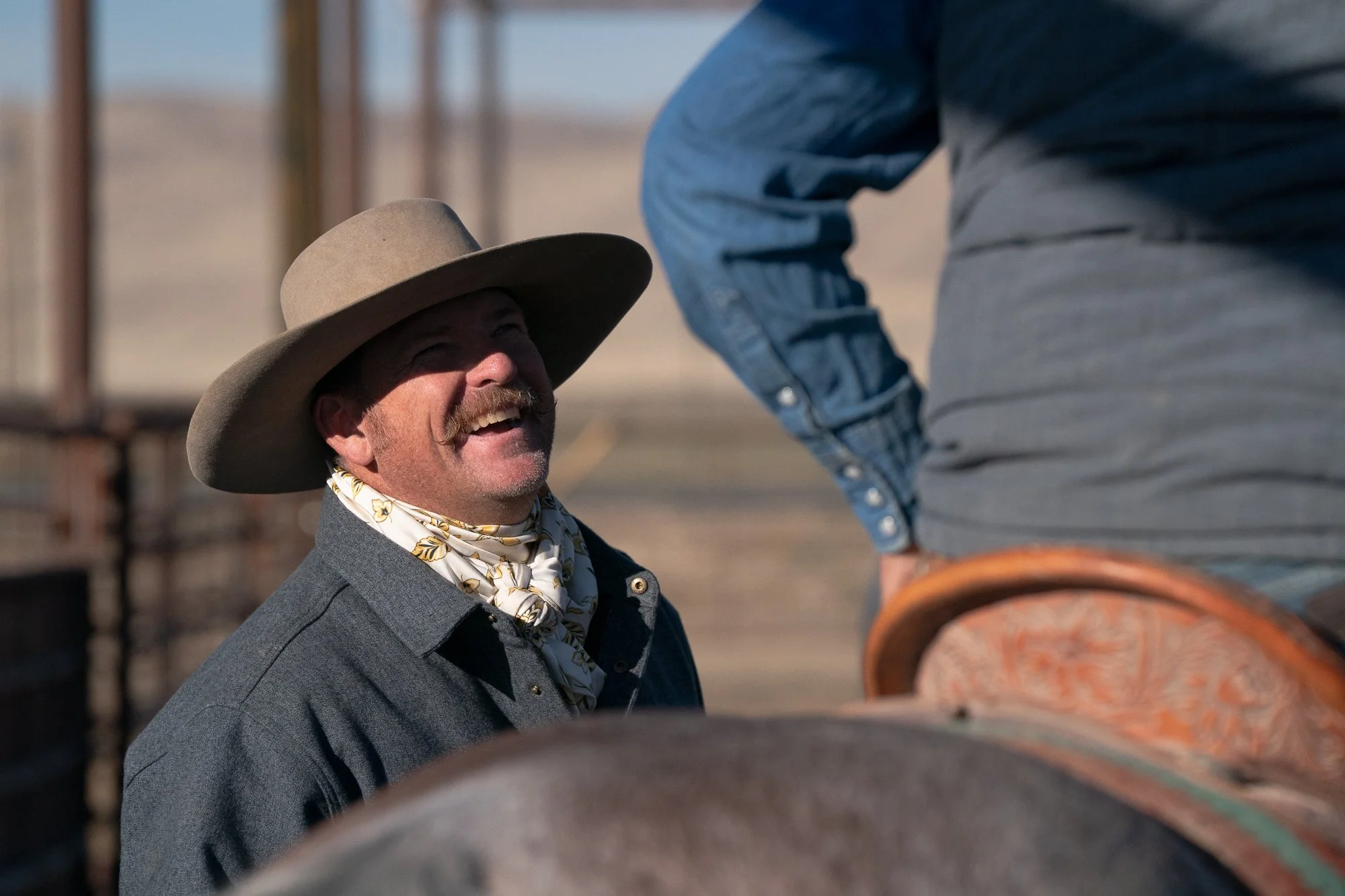 Candid portrait of cowboy smiling during ranch work at TS Ranch