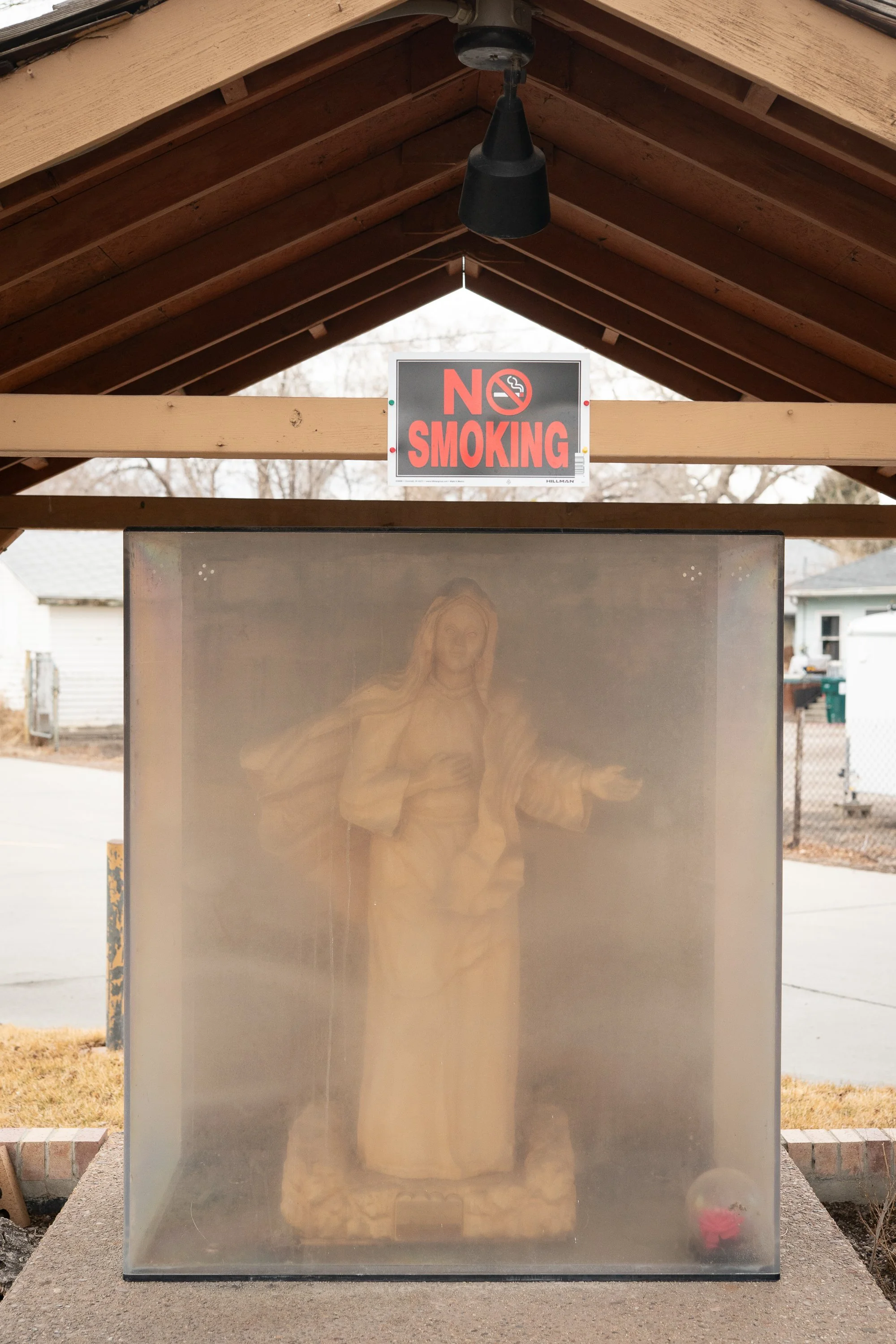 Statue of Jesus inside a glass case beneath a No Smoking sign in Rock Springs Wyoming