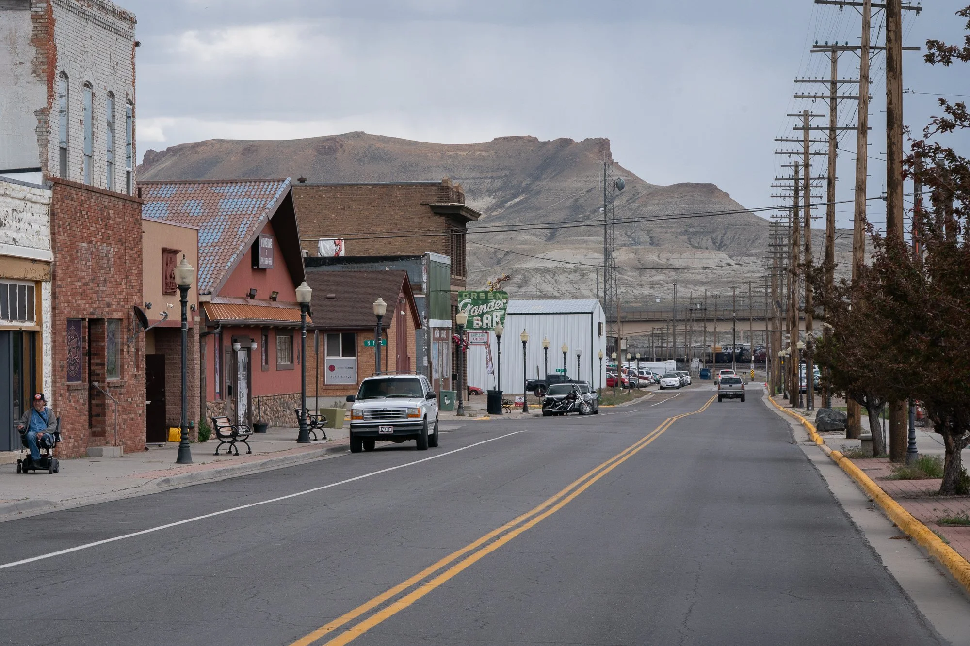 Wyoming small town street with storefronts and mountains in the distance