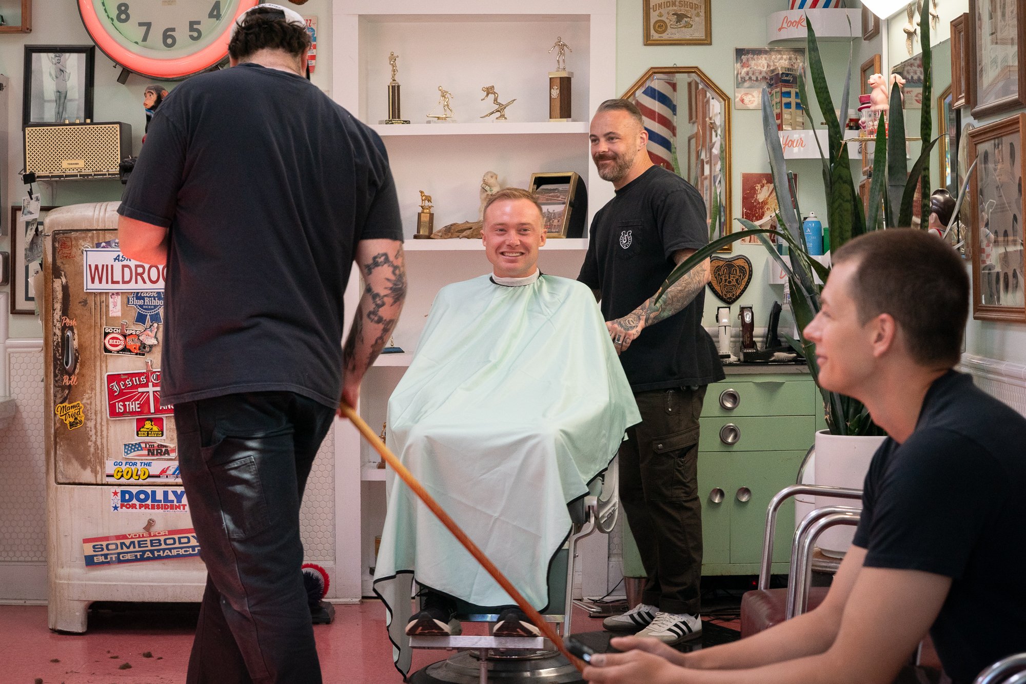 Client smiling during a haircut inside Spanky’s Barbershop in Covington, Kentucky.
