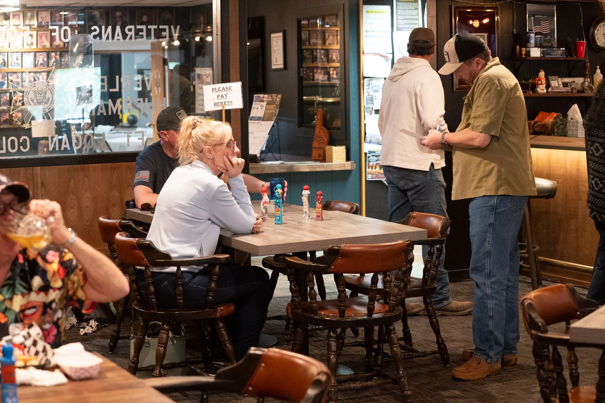 People gathered at tables inside a VFW hall during an authentic veterans brand campaign