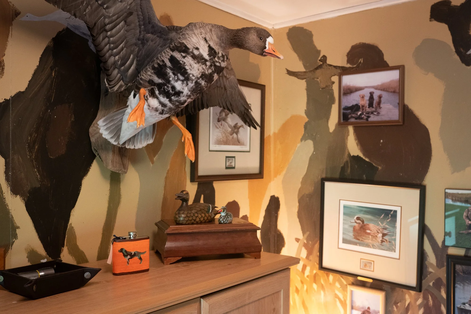 Mounted waterfowl and hunting decor fill a lodge interior in Ontario
