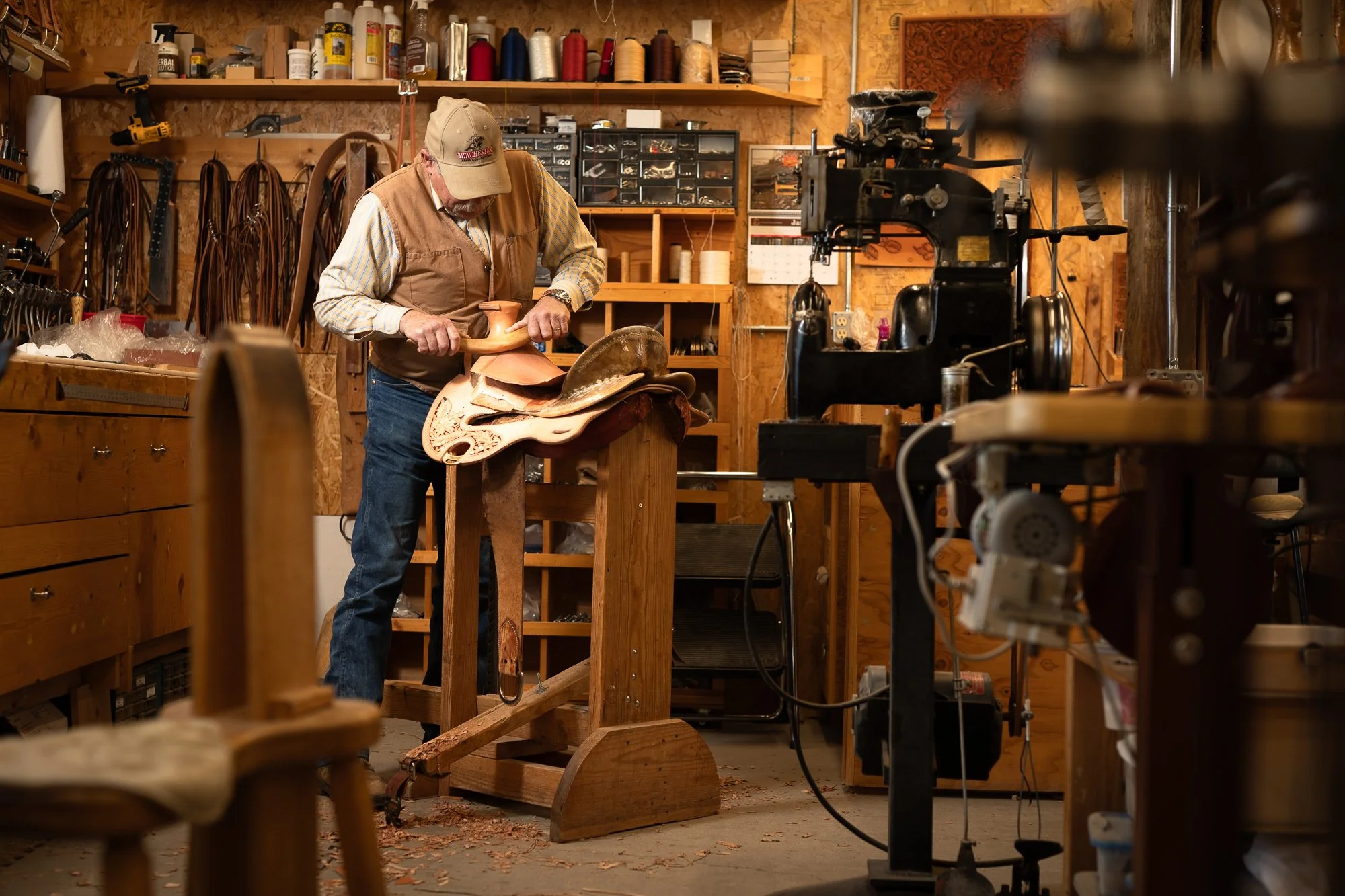 Photograph of a master saddle maker in his workshop