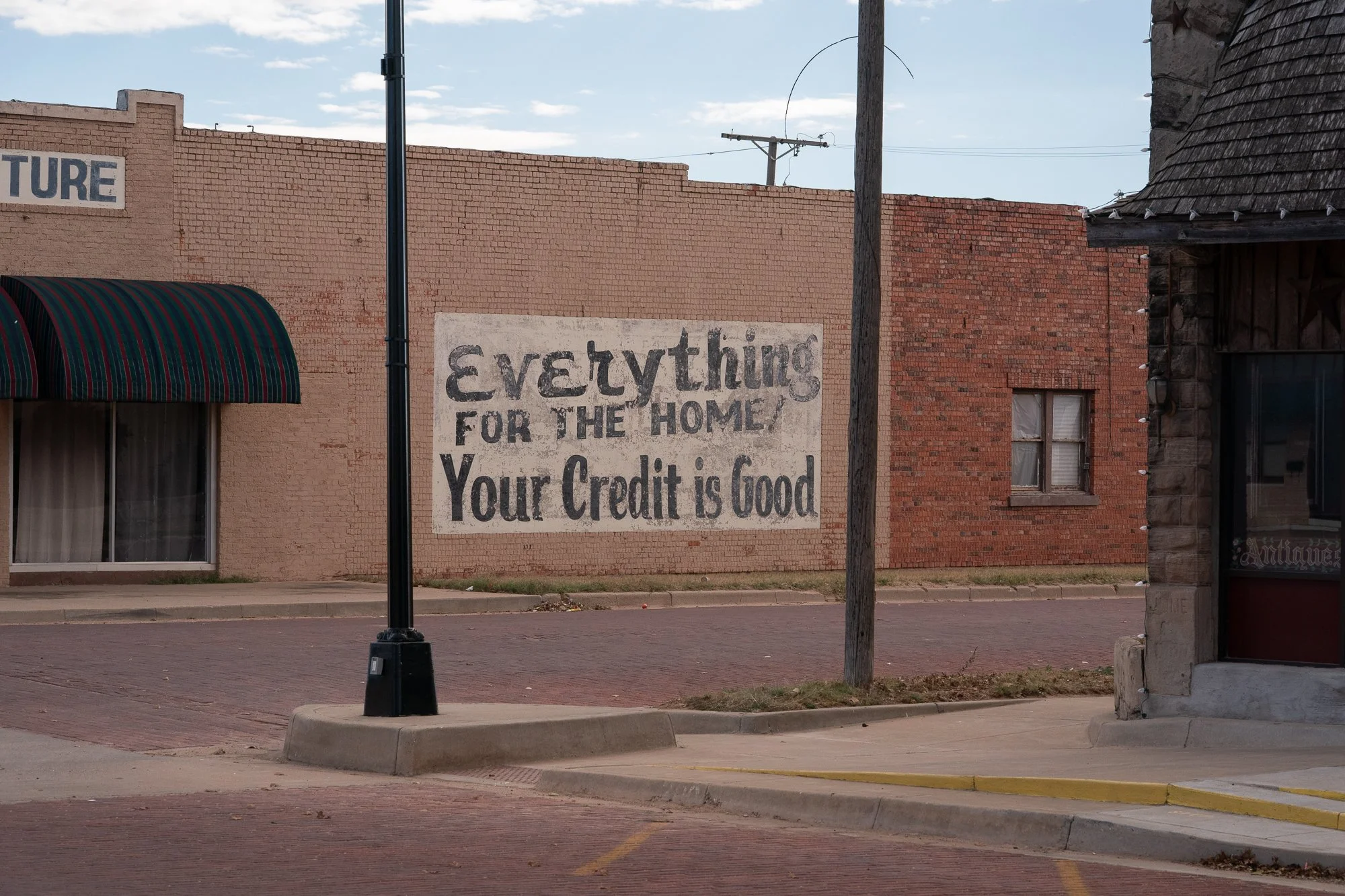 Vintage wall sign reading Your Credit Is Good in a small town on the Llano Estacado