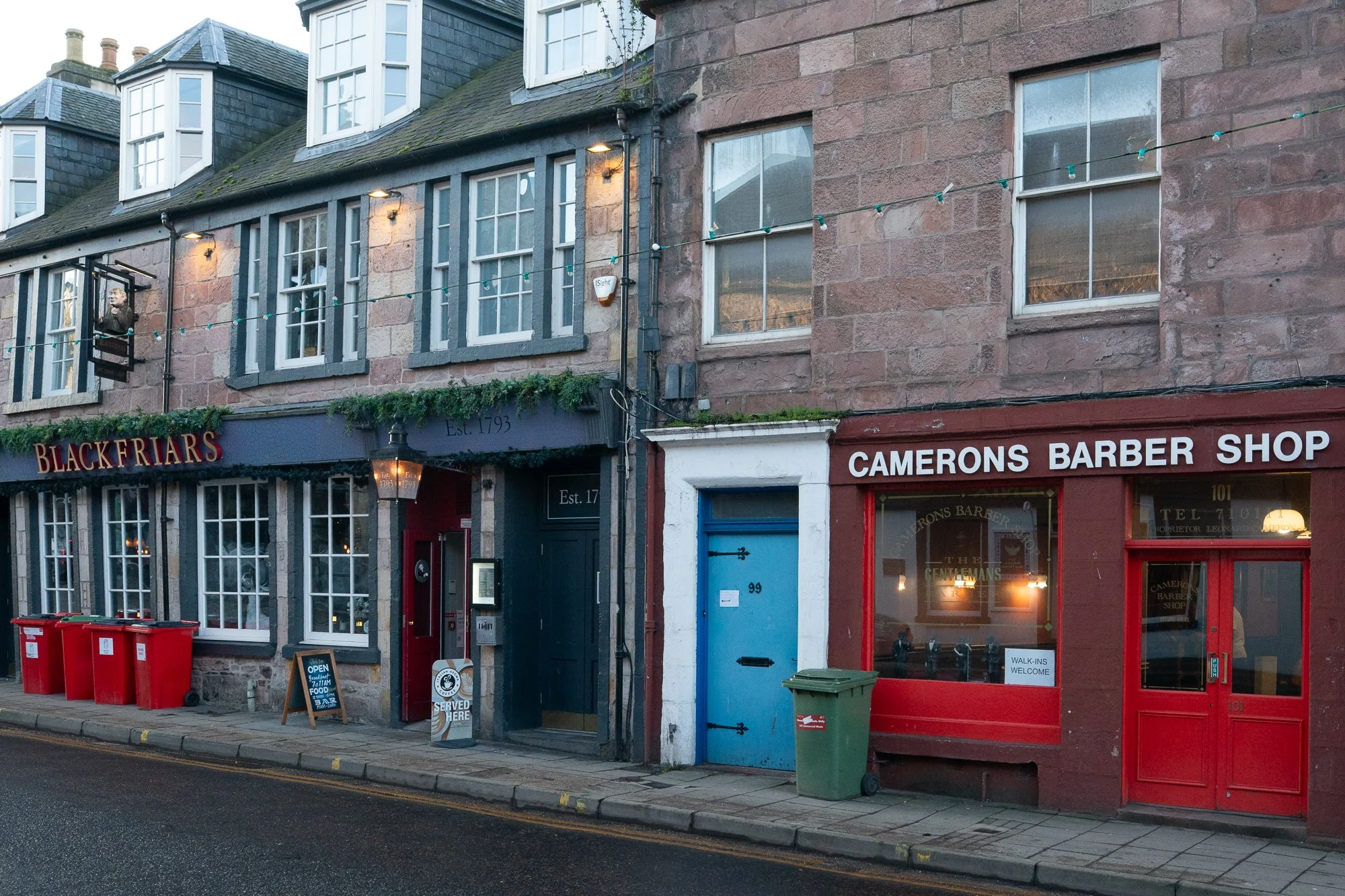 camerons barber shop red storefront on traditional scottish street