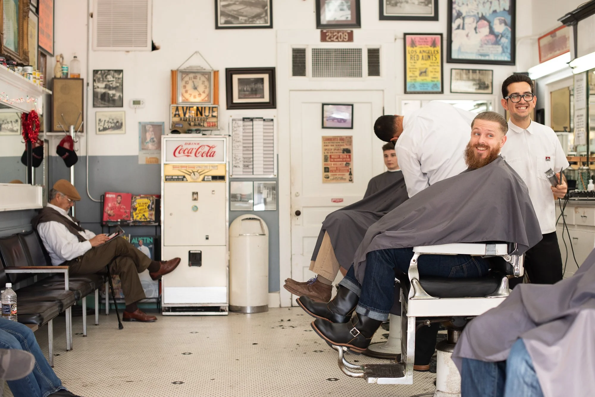 A haircut in progress at Avenue Barbershop in Austin, Texas, where a new generation of barbers carries forward a tradition that dates back to 1933.