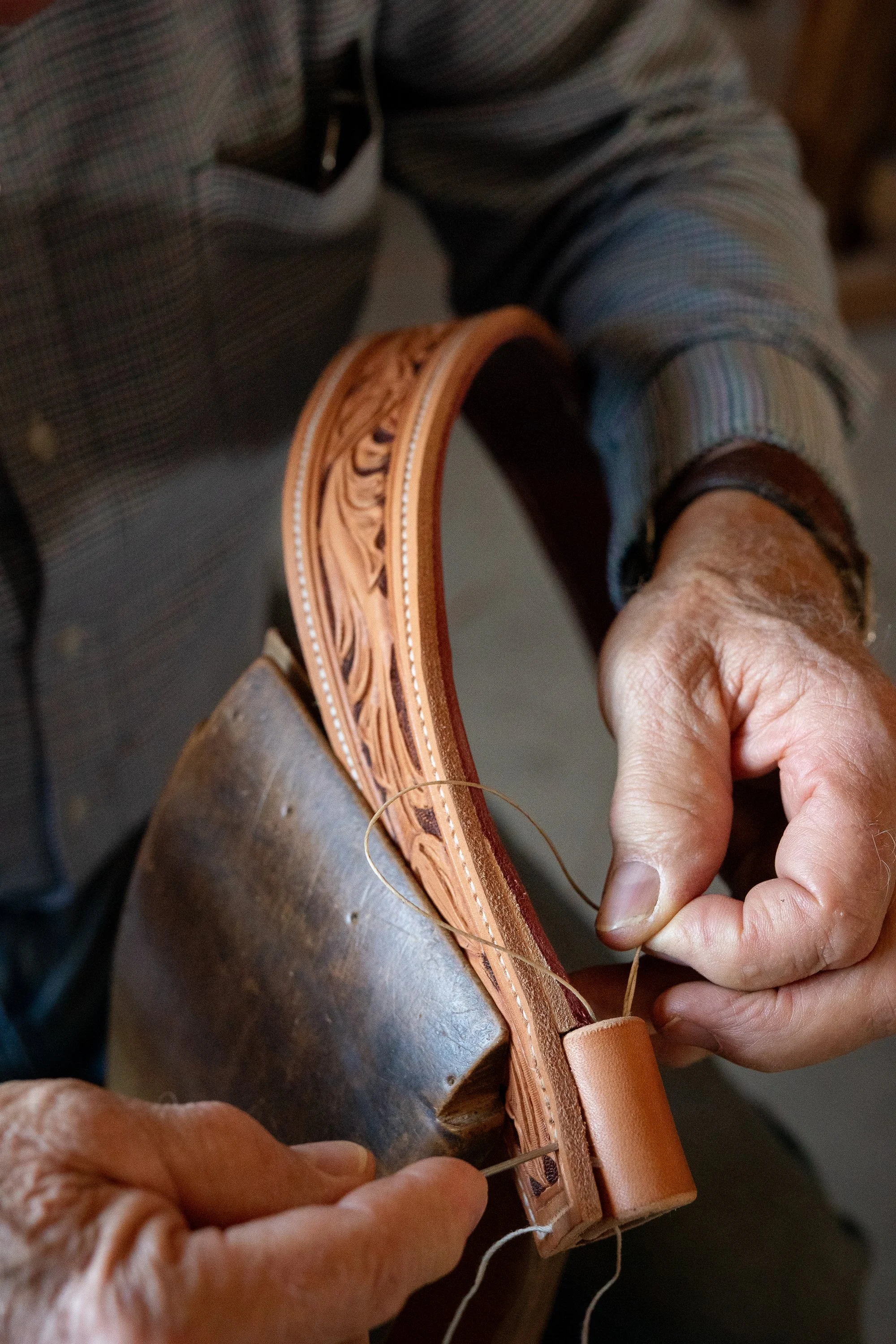 Doug Cox stitching leather on a Mother Hubbard saddle.