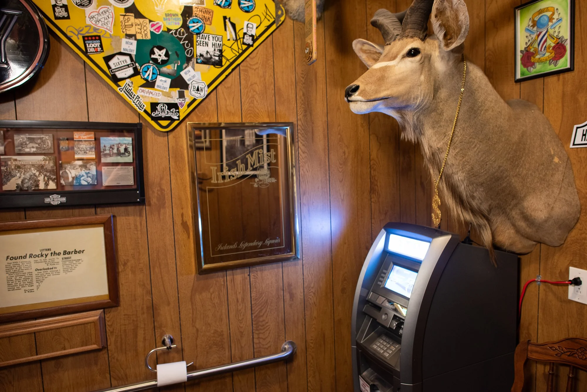 Wall decorations and ATM inside Joe’s Barbershop in Chicago