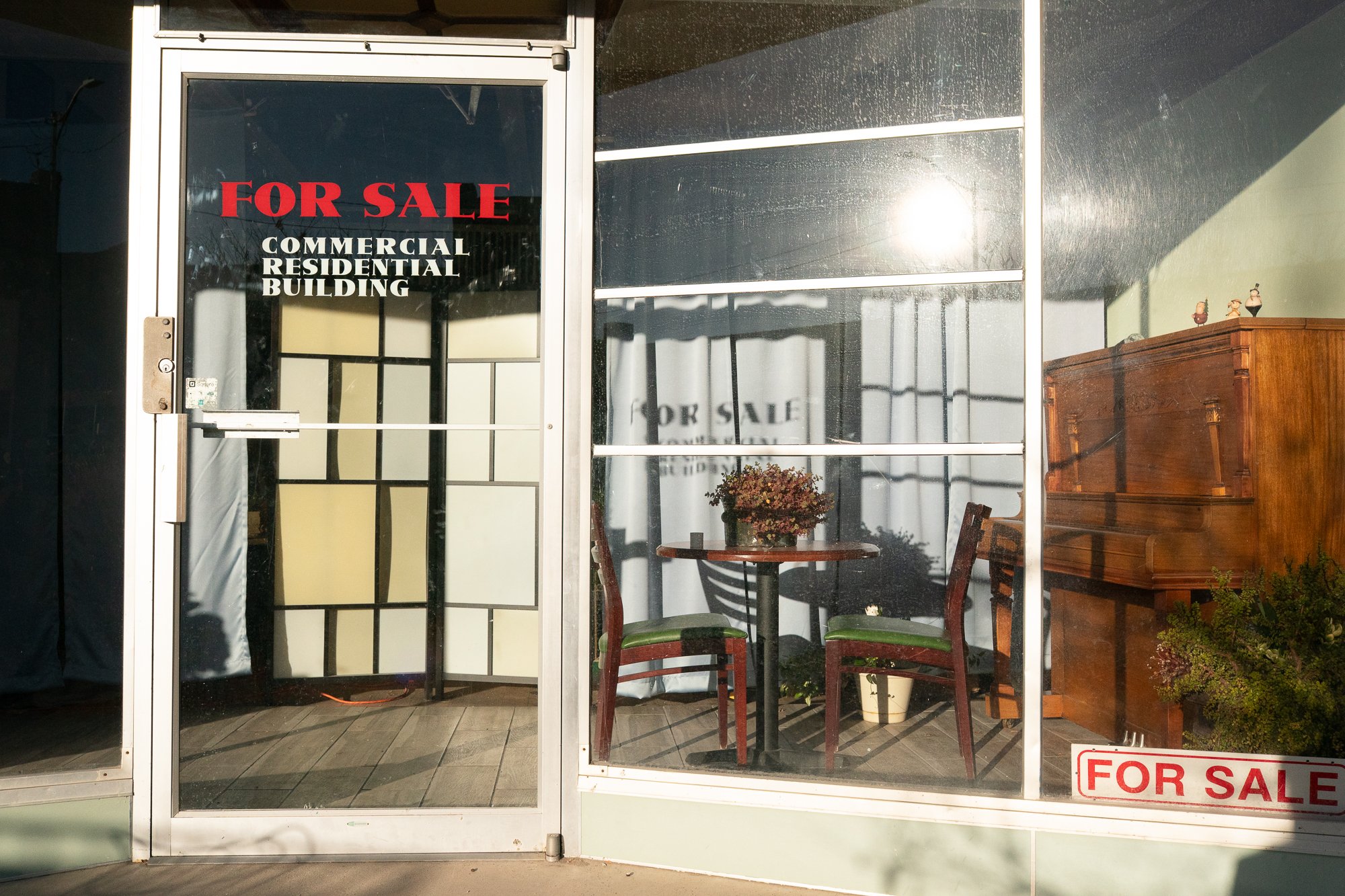 For sale sign on commercial storefront window in Helper Utah