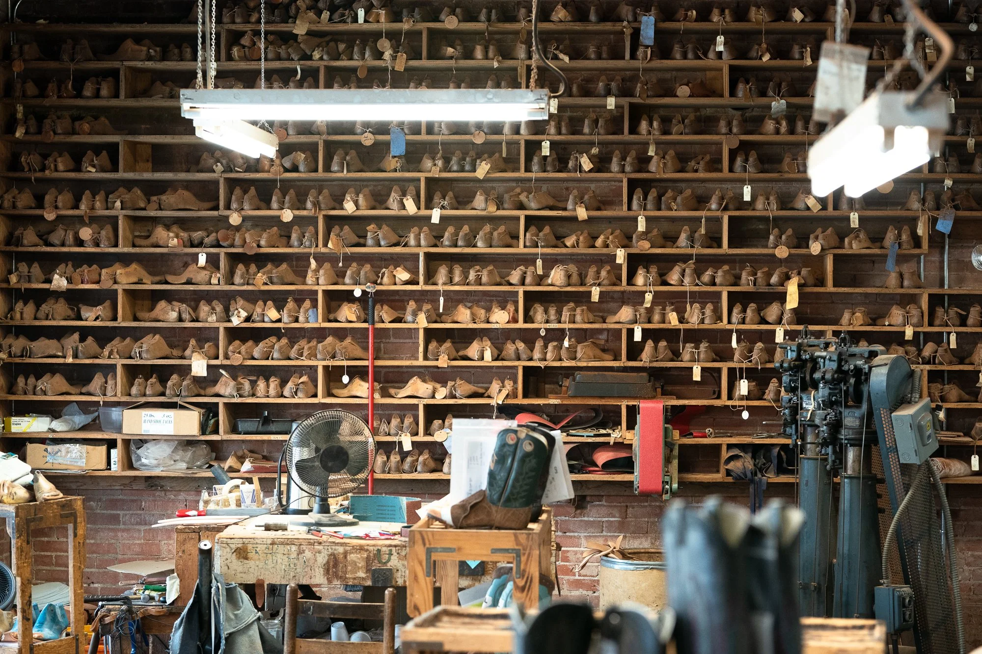 Interior of ML Leddy’s boot workshop with shelves of wooden lasts in San Angelo Texas