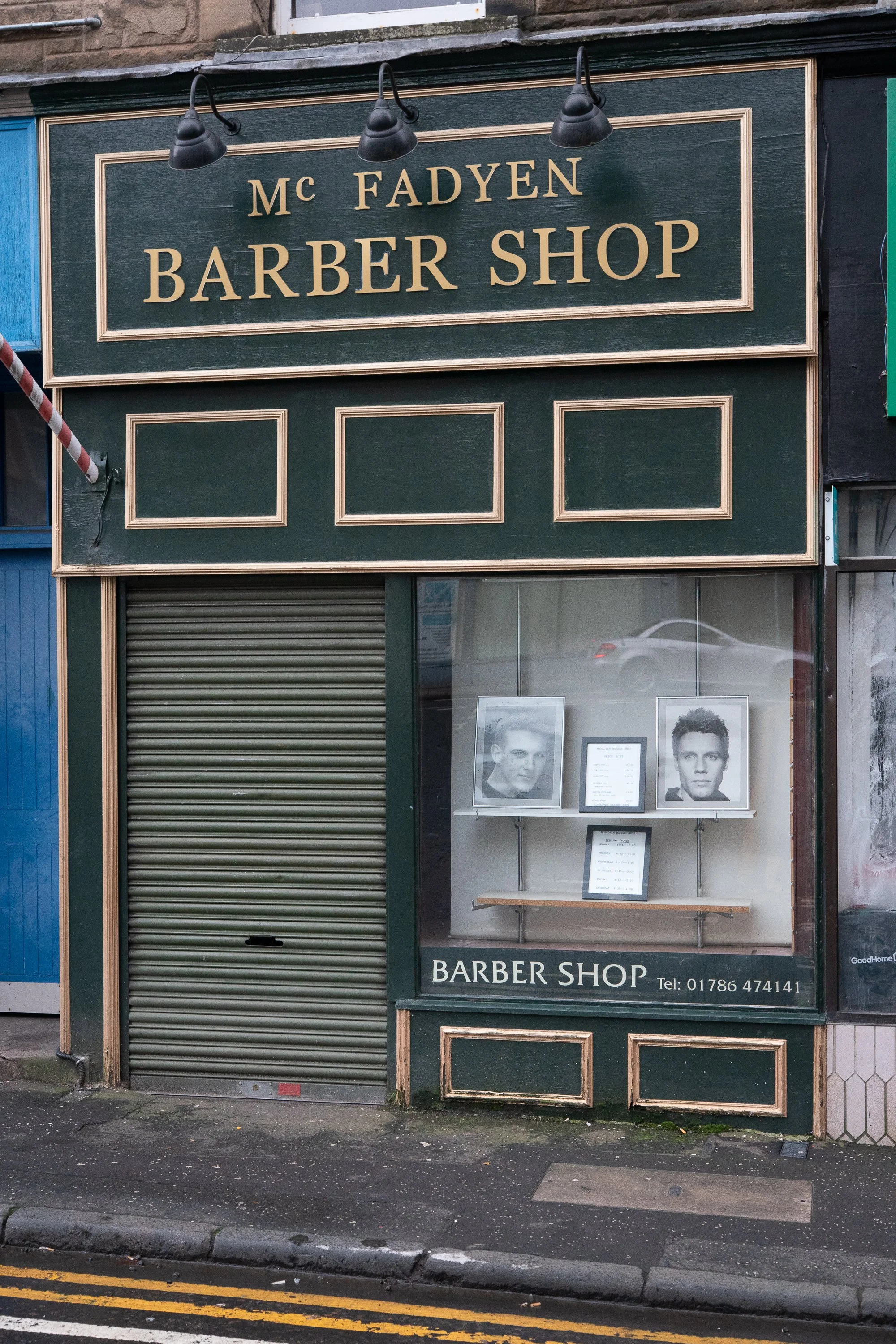 mcfadyen barber shop storefront with traditional signage and display window