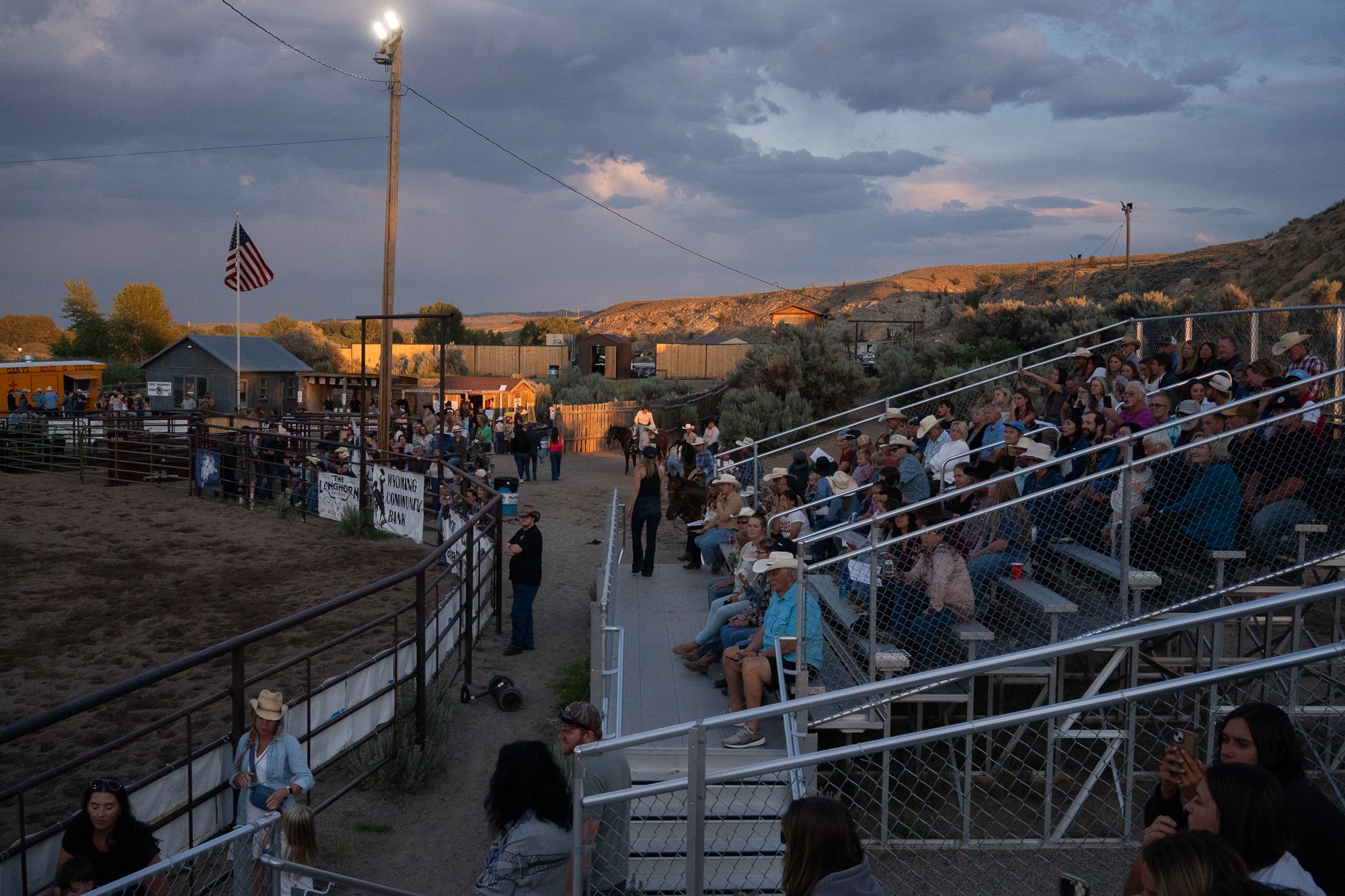 Spectators fill the grandstands as evening settles over the Dubois Rodeo in Wyoming