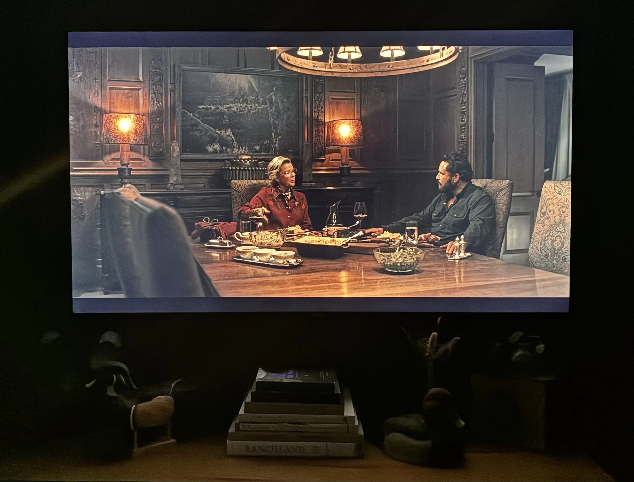 Cowboy photography print displayed on the wall behind a dining table scene on Dutton Ranch