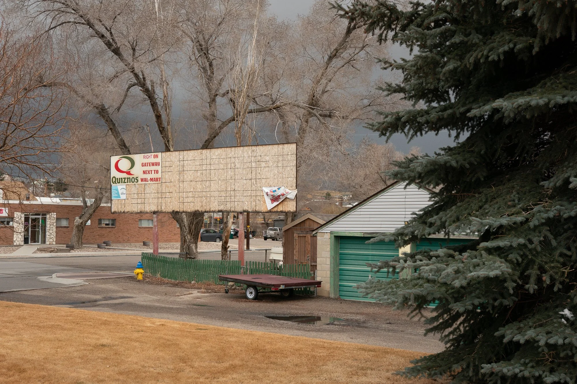 Old faded Quiznos restaurant sign along street in Rock Springs Wyoming