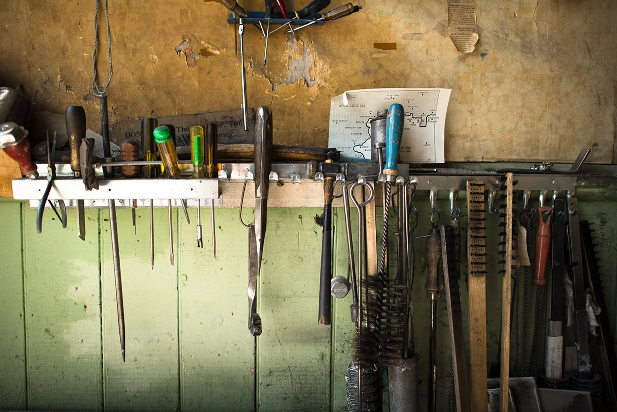 Printing and repair tools hanging on a wall inside the Saguache Crescent