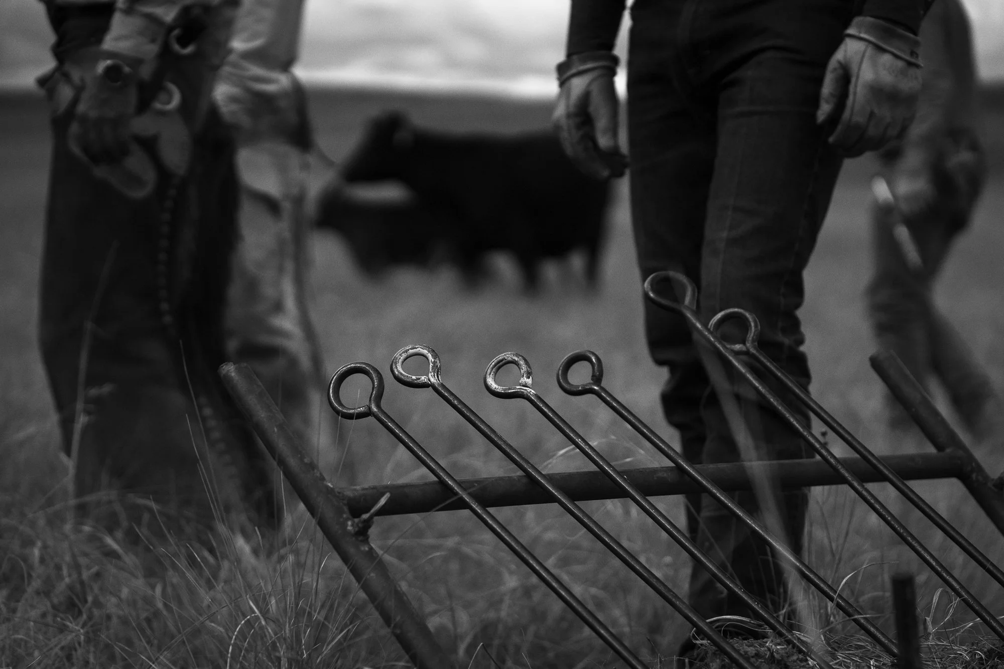 Branding irons and gloved ranch hands photographed during a working ranch documentary project