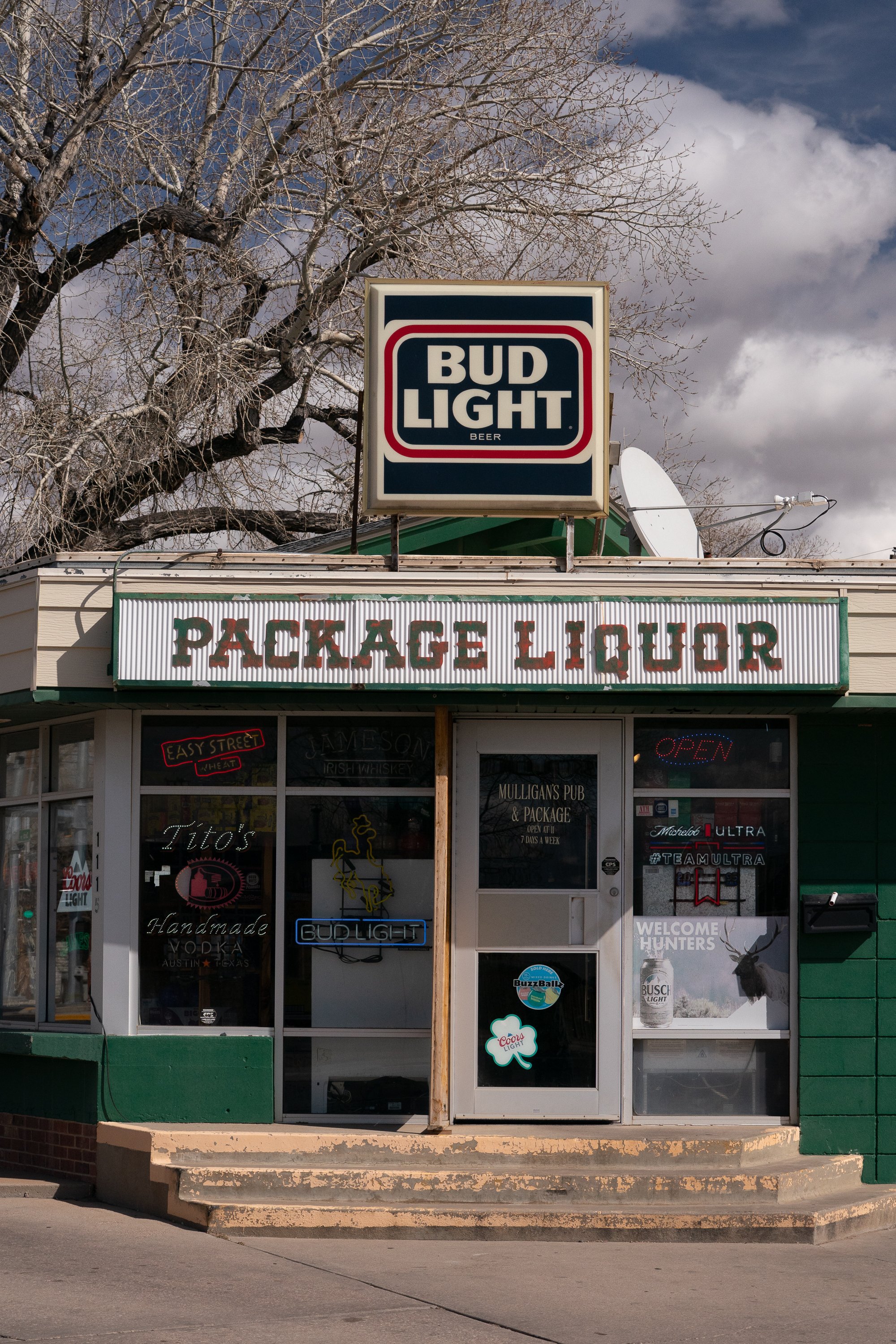 Package liquor storefront with Bud Light sign in a Wyoming town