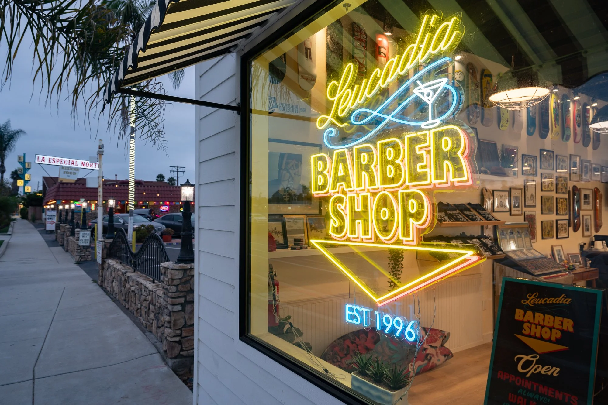 Neon sign at Leucadia Barbershop in Encinitas, California at dusk, established 1996.