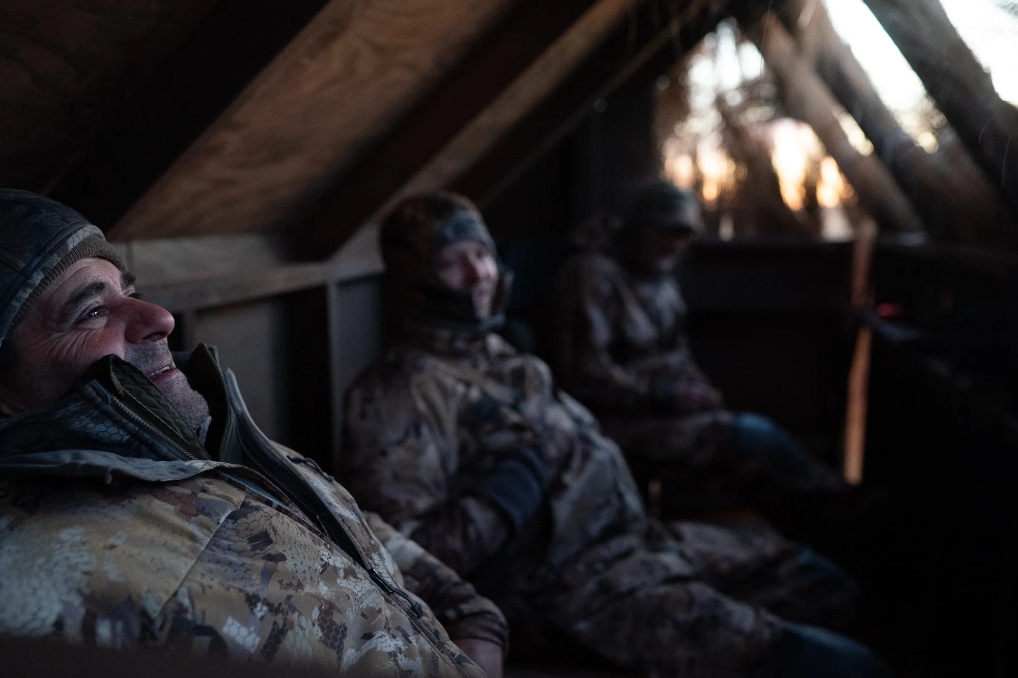 Duck hunters sit inside a blind in the Nebraska marsh before first light