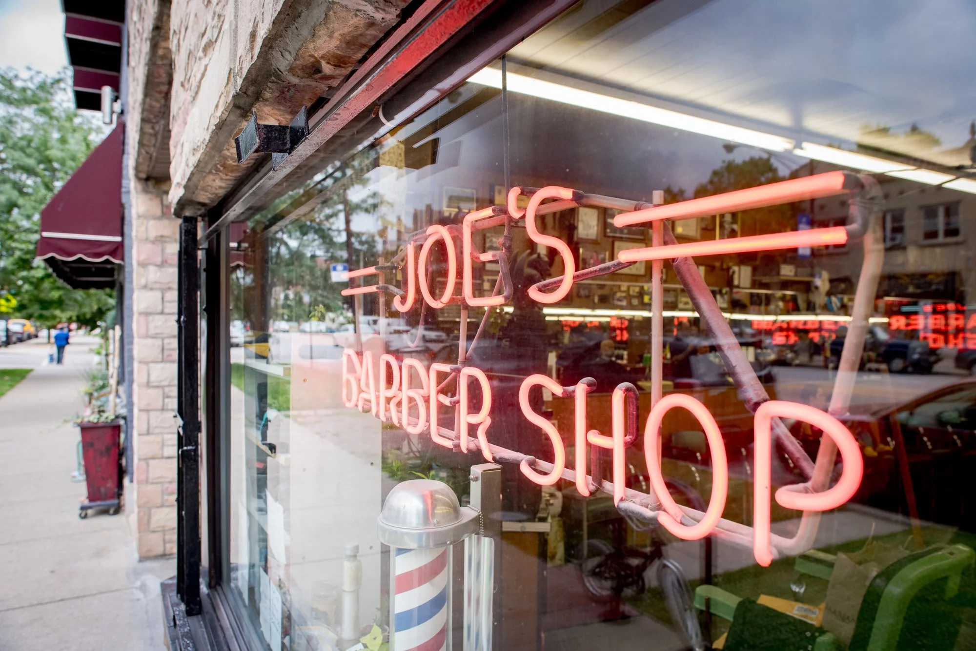 Neon sign outside Joe’s Barbershop in Chicago