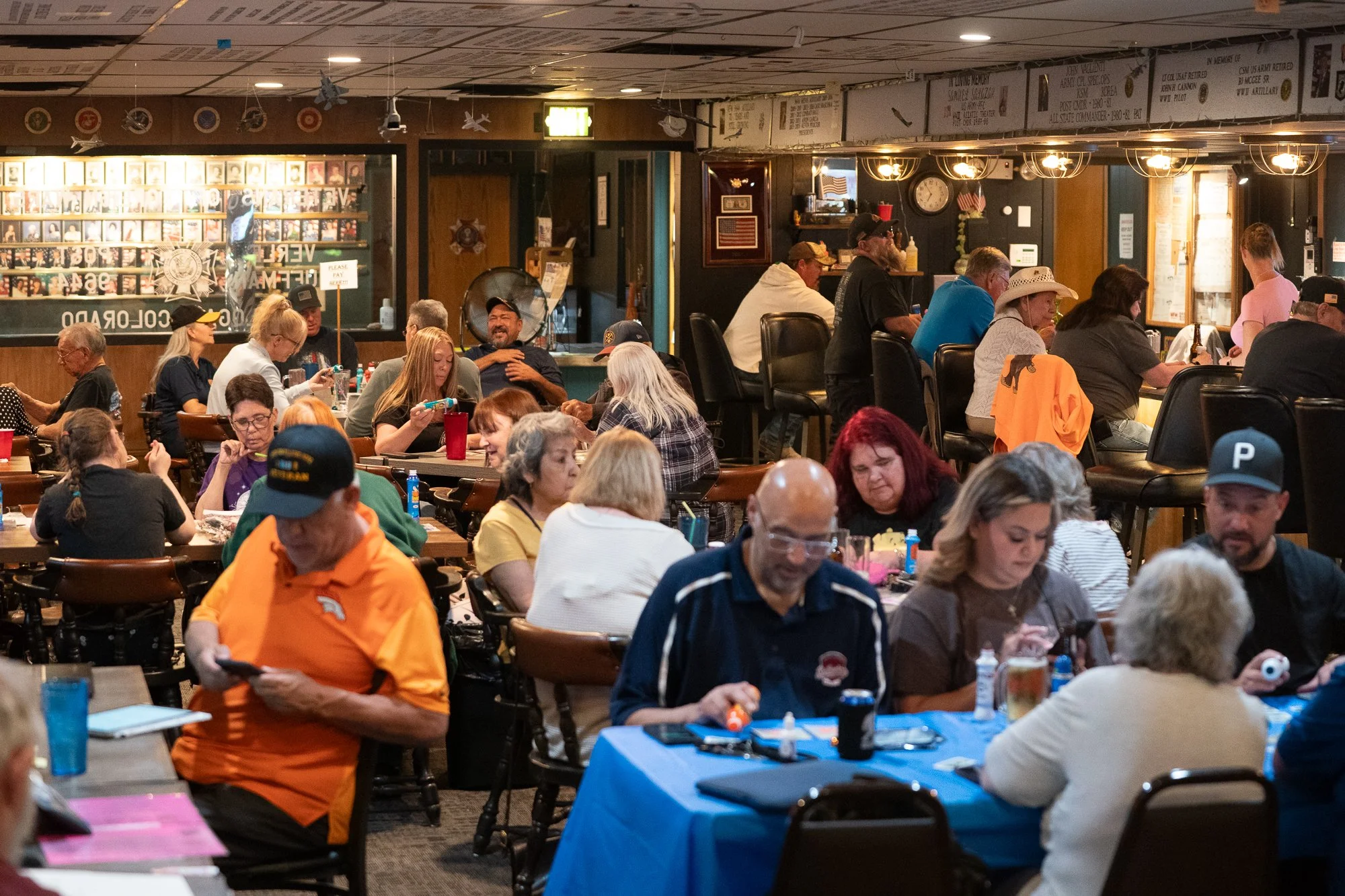 Crowded VFW hall with people gathered at tables during an authentic veterans brand campaign