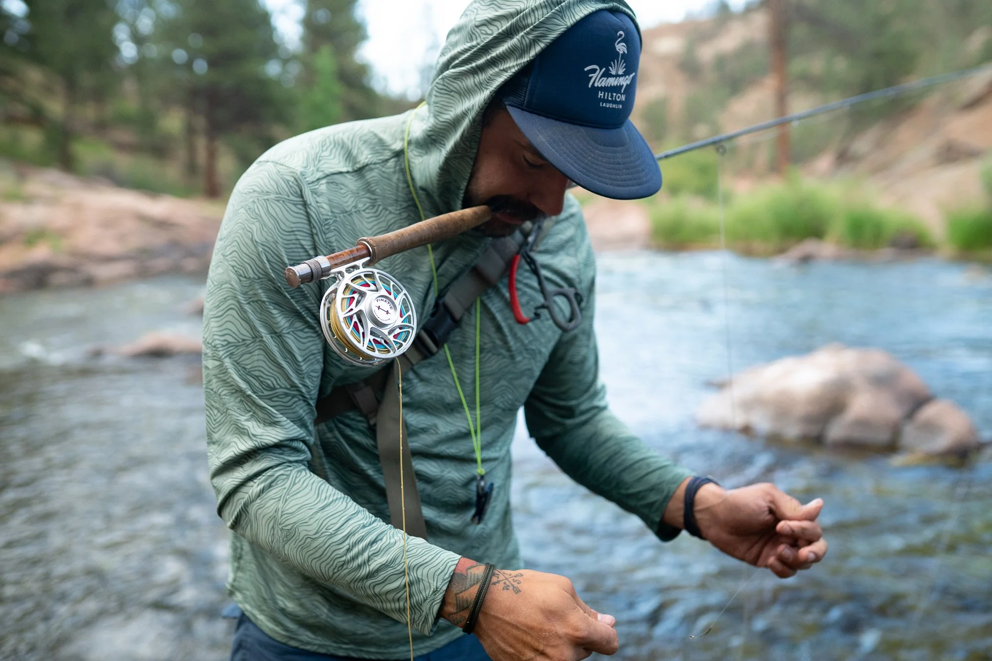 Angler handling fly fishing line beside the South Platte River near Deckers, Colorado