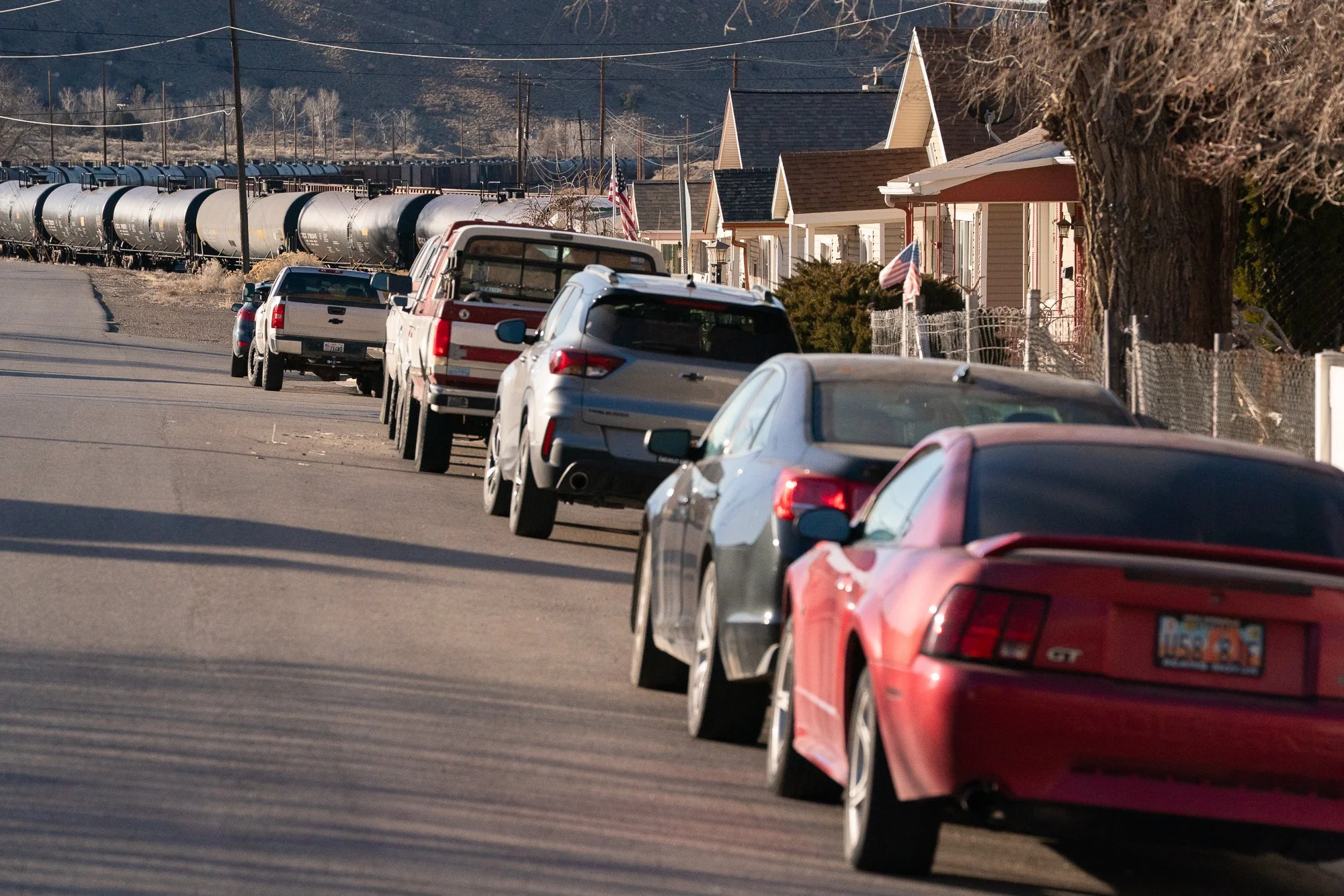 Residential street in Helper Utah with tanker rail cars in background
