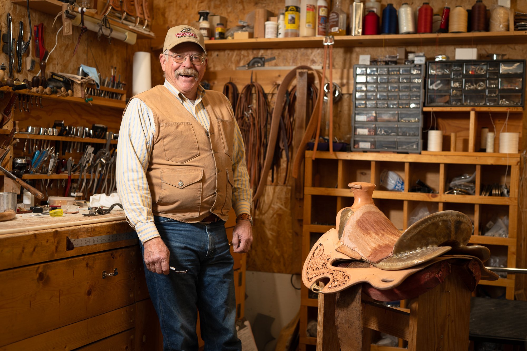 Portrait of Western saddle maker Doug Cox inside his workshop
