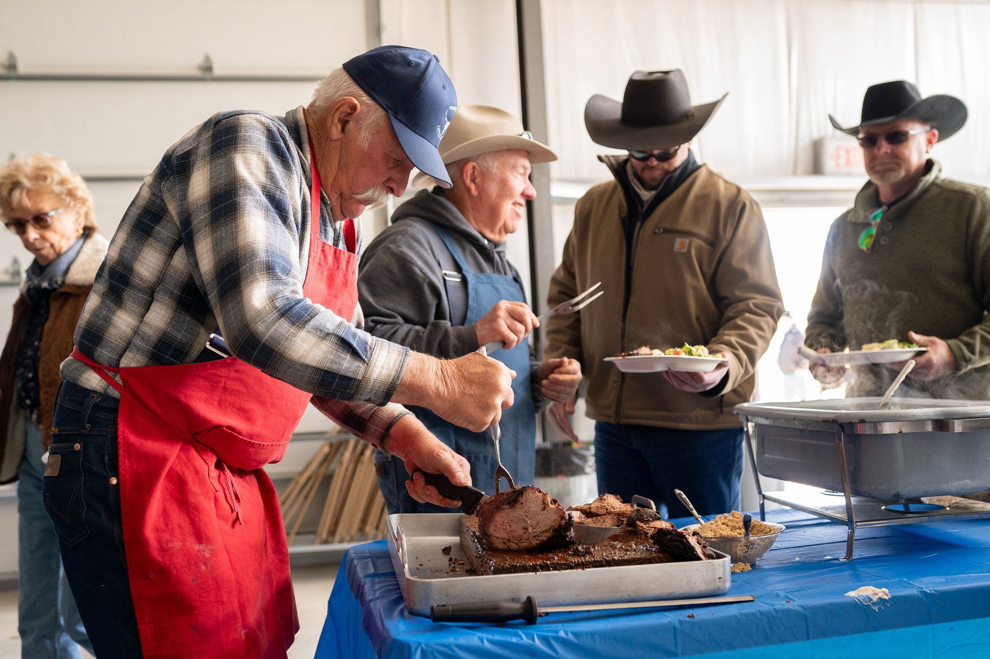 Man serving food to ranchers during a Nevada bull sale