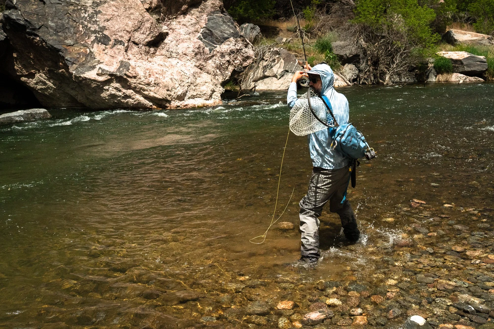 An angler casts while wading the Gunnison River in the Black Canyon
