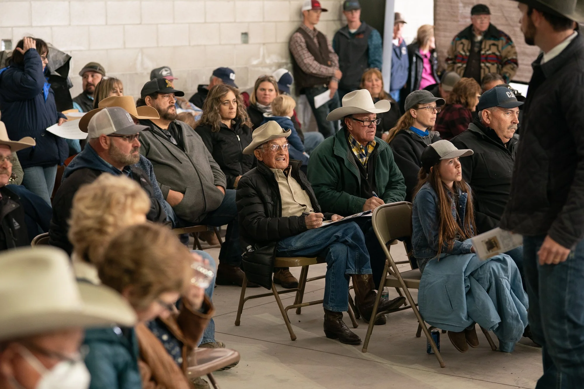 Ranchers and families seated during a Nevada bull auction