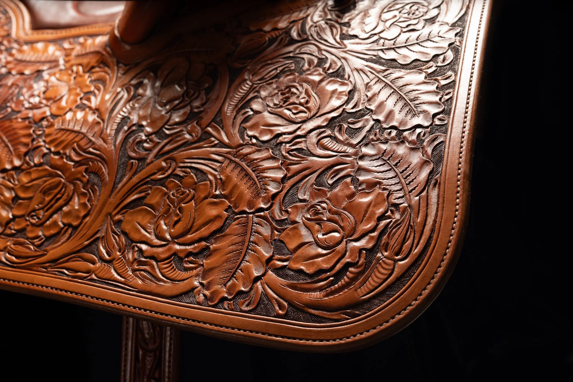 Floral leather tooling on the skirt of a finished Mother Hubbard saddle.