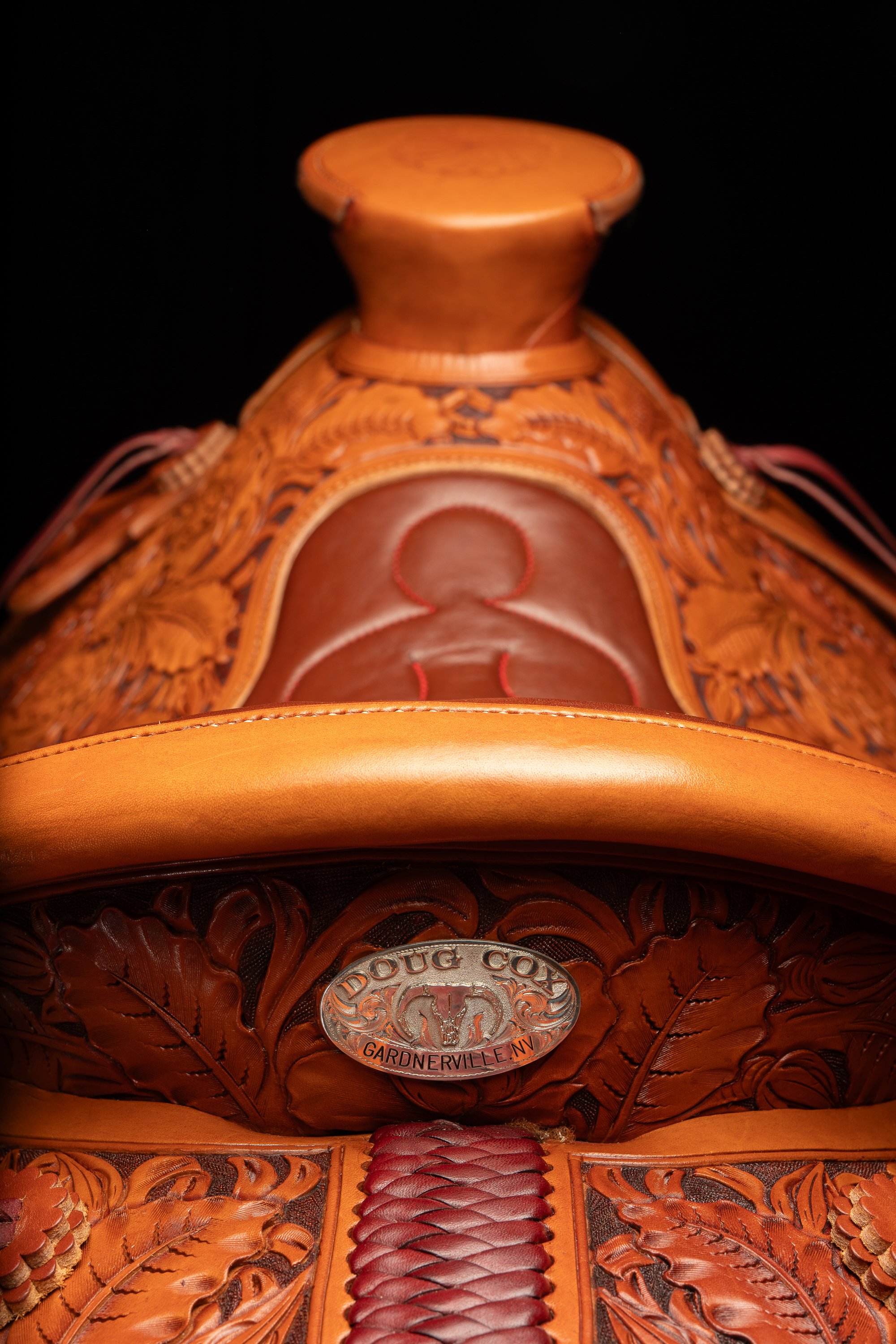 Doug Cox maker's badge and carved leather details on a Mother Hubbard saddle.