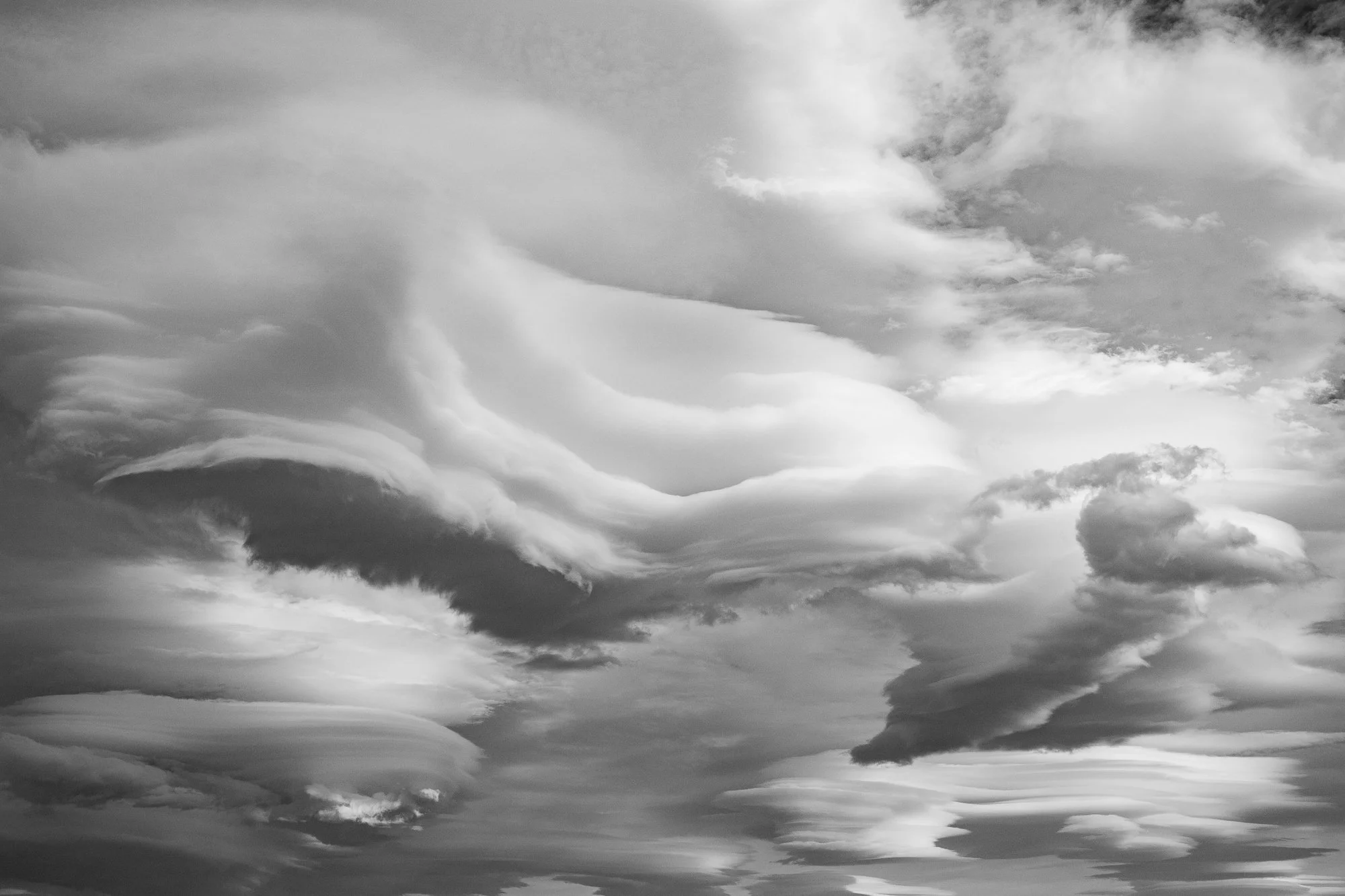 Black and white photograph of large layered clouds over the California desert