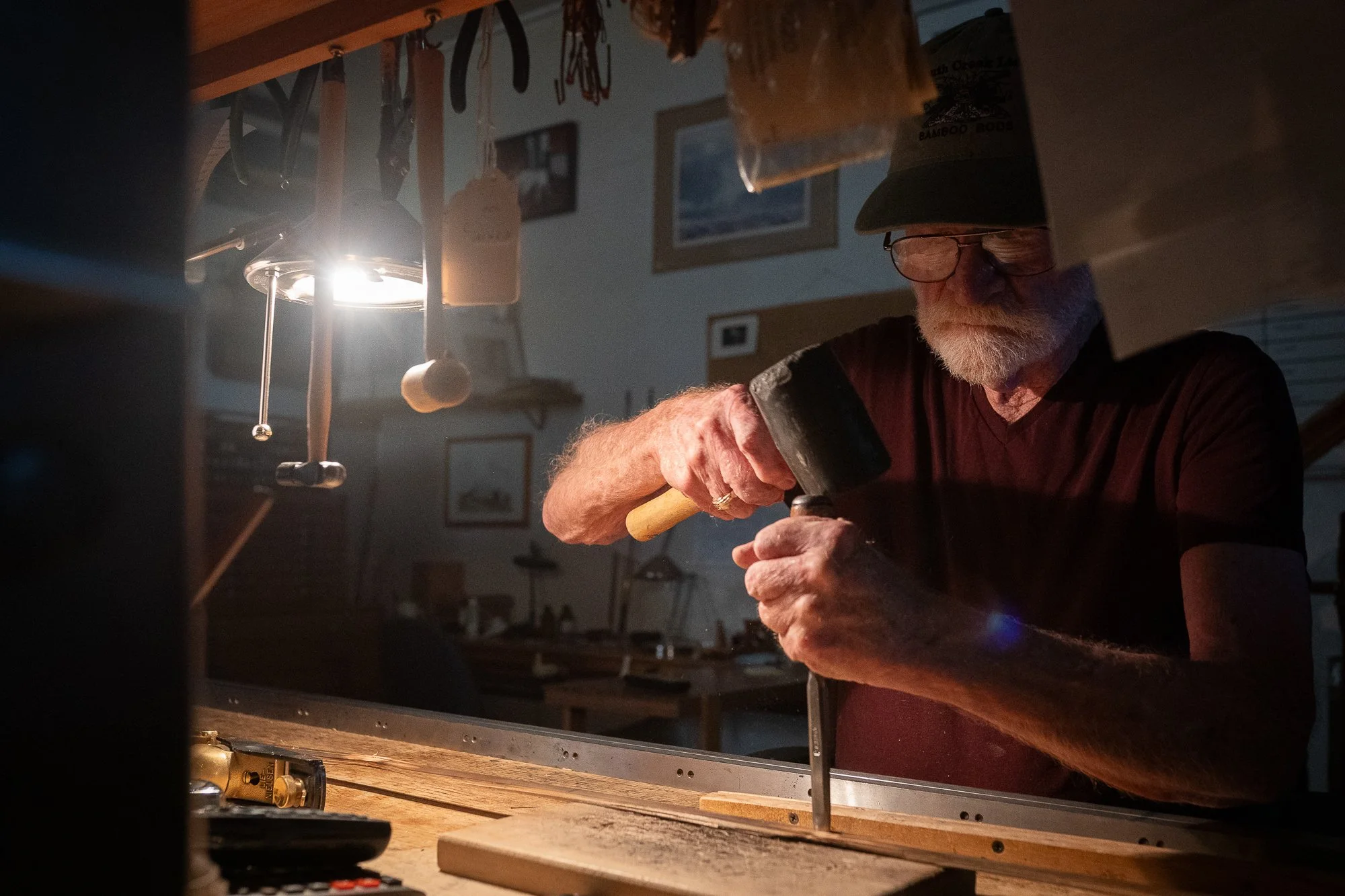 Mike Clark working on a handmade bamboo fly rod at his workbench in Lyons, Colorado.