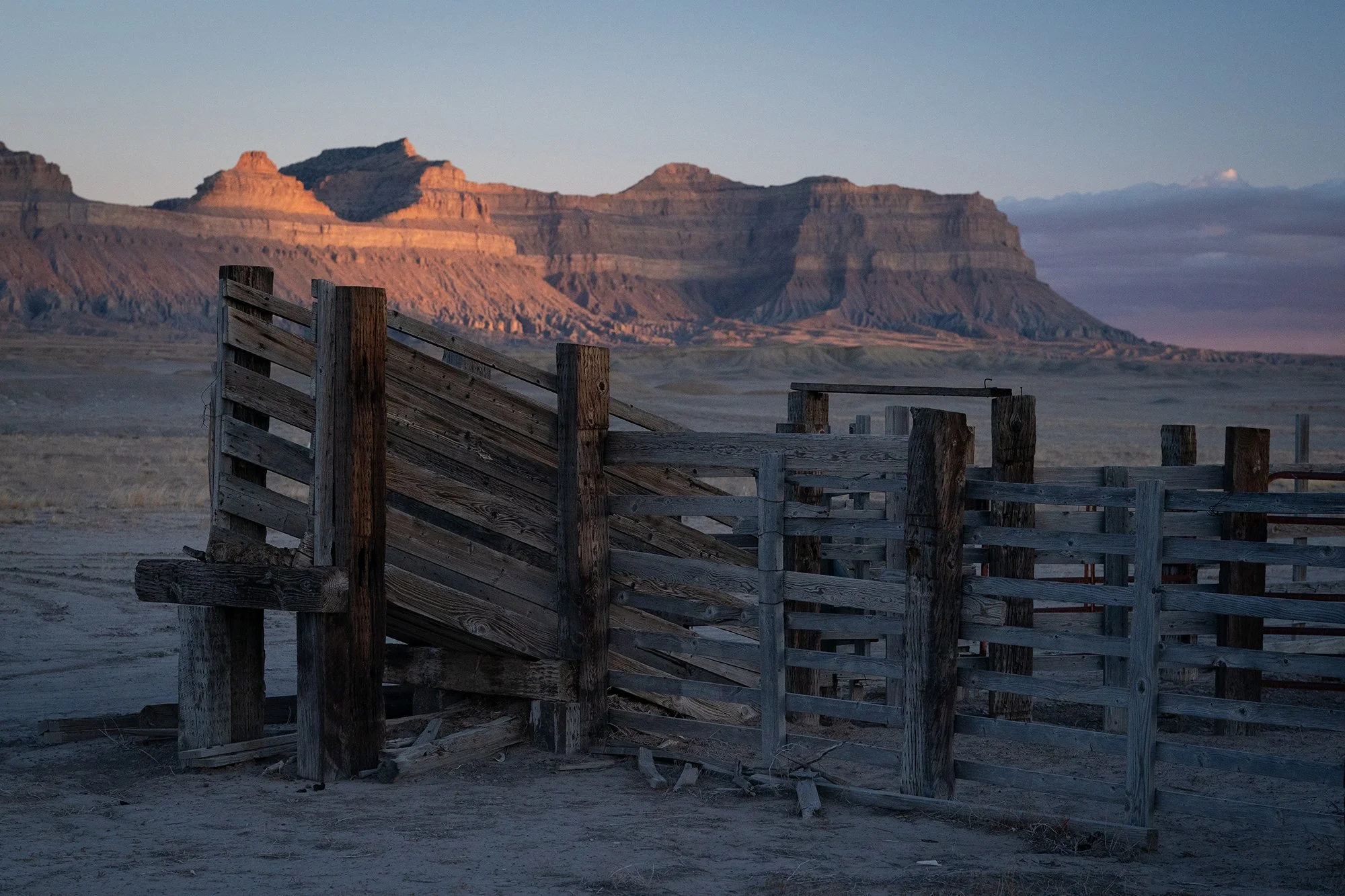 Old wooden cattle corral on a remote Utah ranch with desert mesas in the background