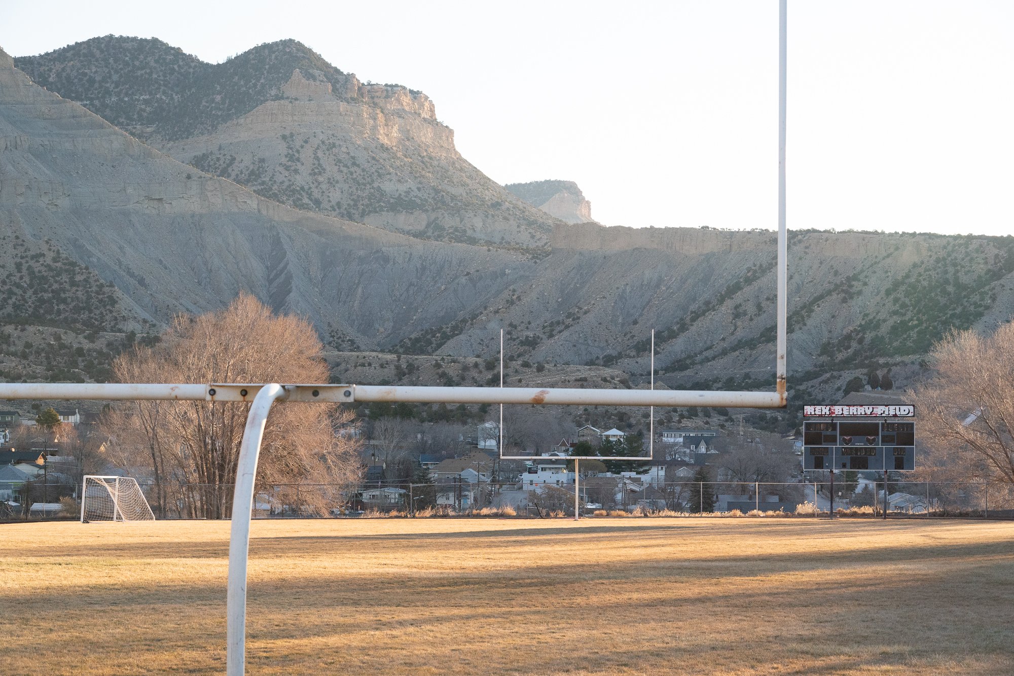 Rex Berry Field football stadium in Helper Utah with Book Cliffs behind