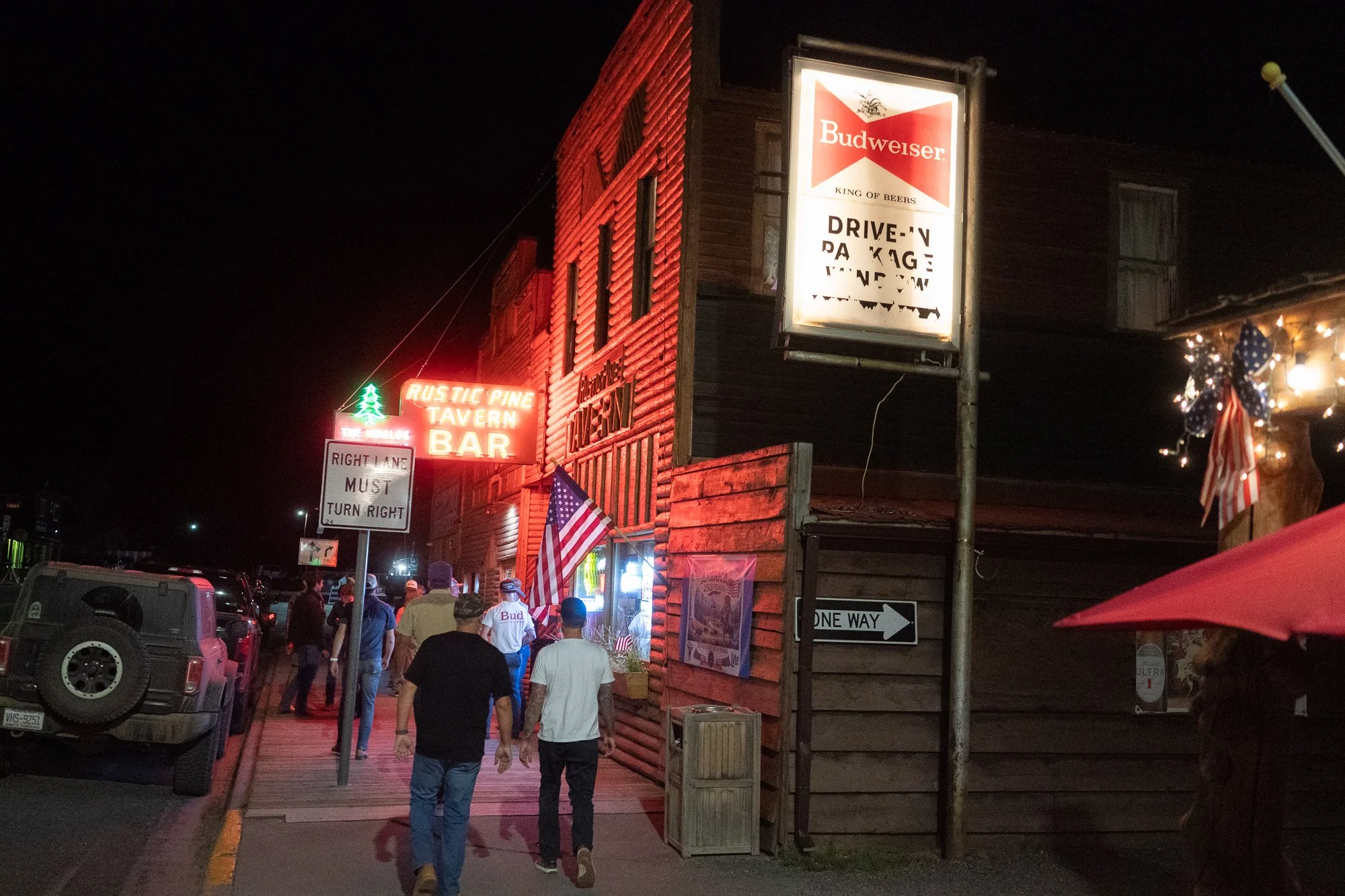 Rustic Pine Tavern in Dubois Wyoming after the rodeo as people gather outside at night