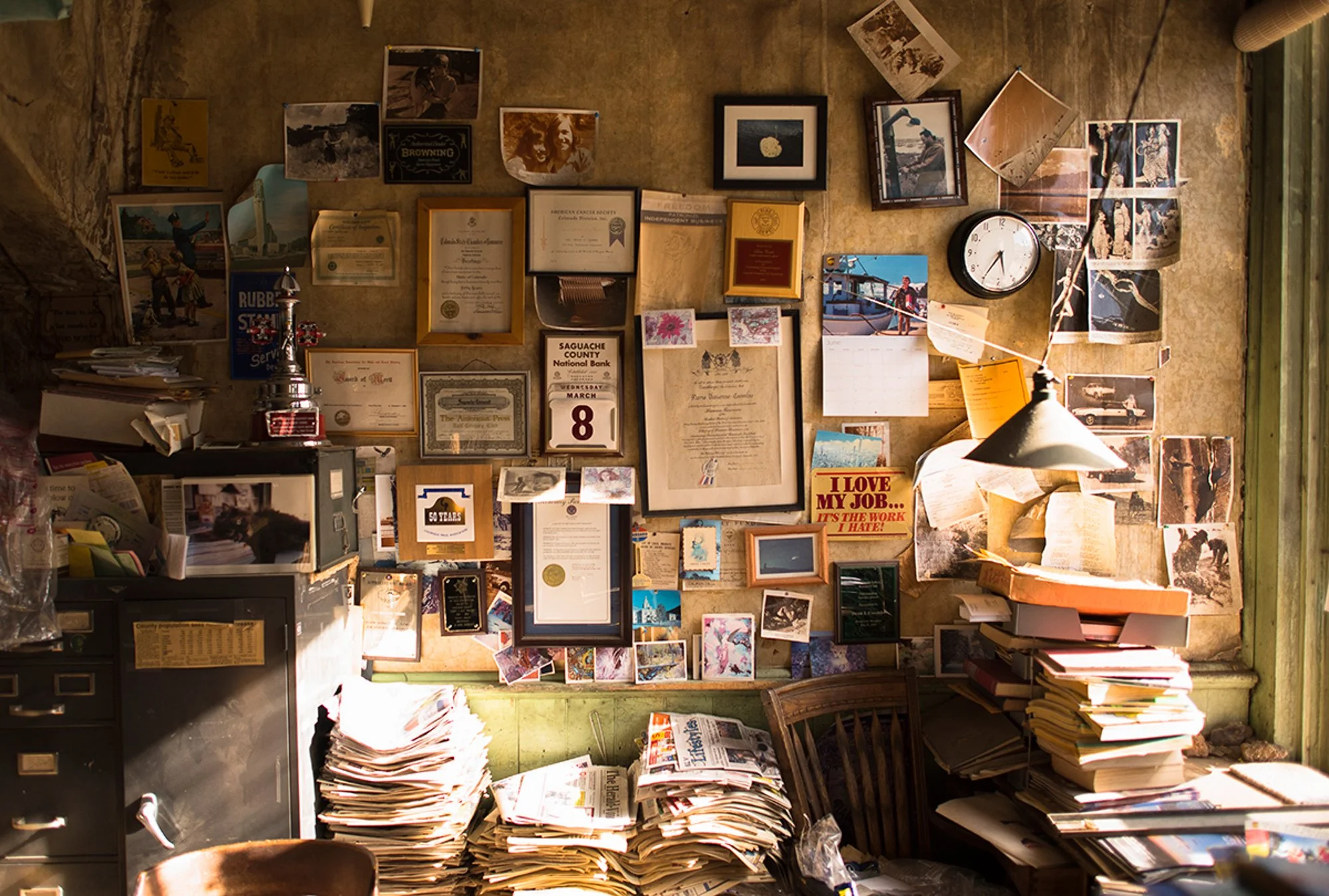 Wall of photographs certificates and newspapers inside the Saguache Crescent