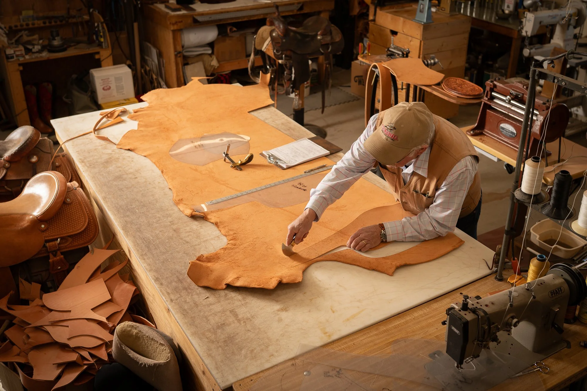 Doug Cox cutting leather for a Mother Hubbard saddle in his Nevada workshop.