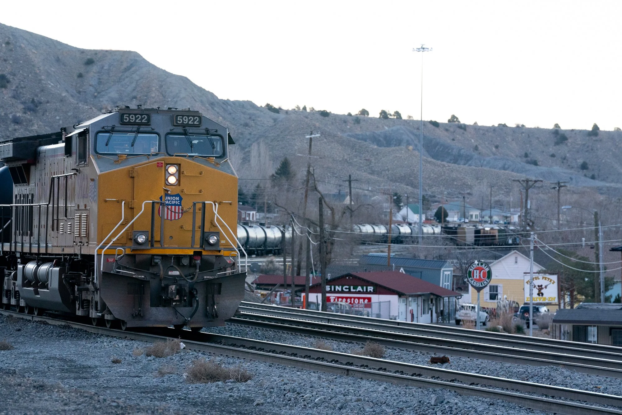Union Pacific freight train passing through Helper, Utah with Book Cliffs in background