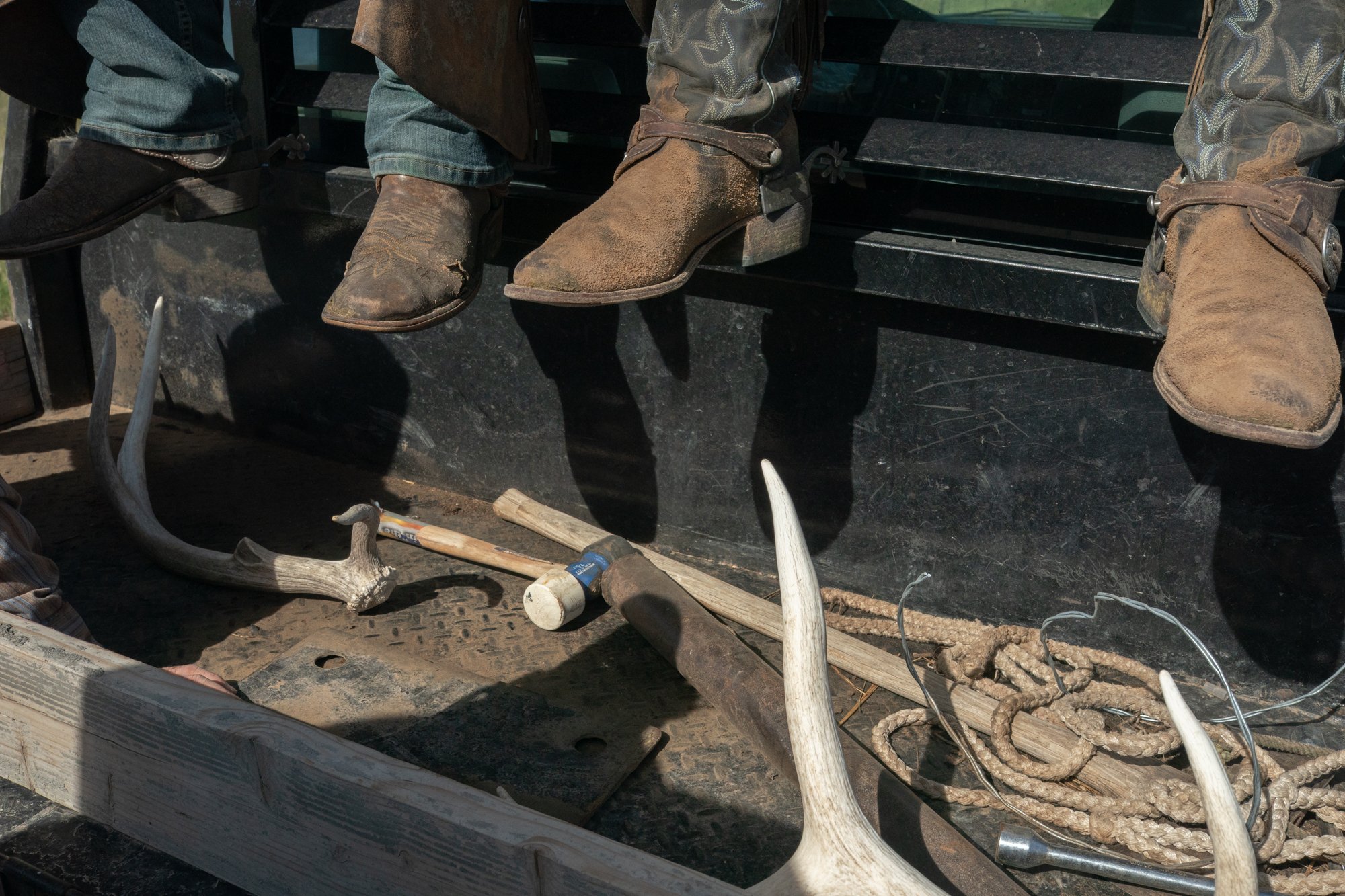Branding tools, rope, antlers, and cowboy boots rest in the tailgate of a ranch truck at Silver Spur Ranch in Colorado