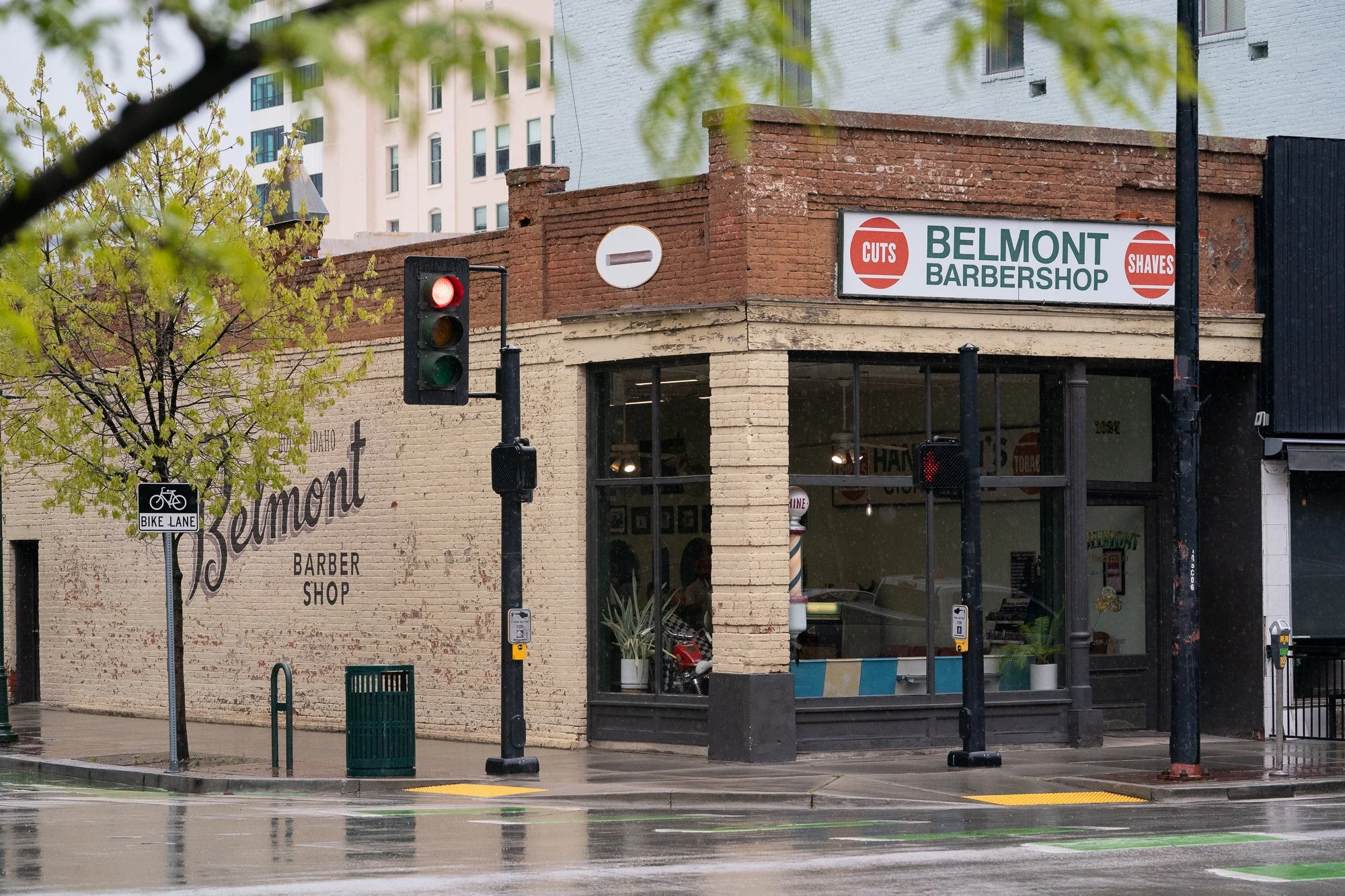exterior of Belmont Barbershop on a rainy street corner in downtown Boise Idaho