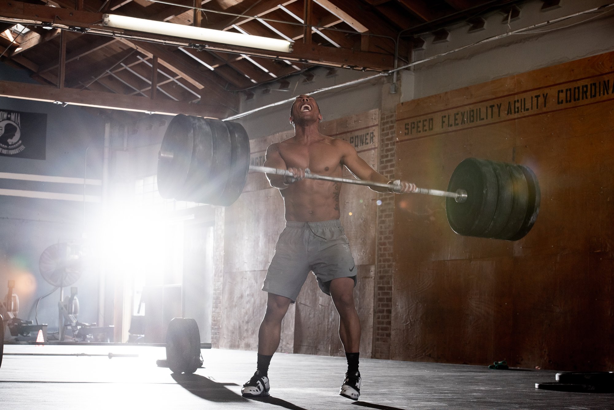 CrossFit athlete lifting a heavily loaded barbell during functional fitness training in Boulder, Colorado.