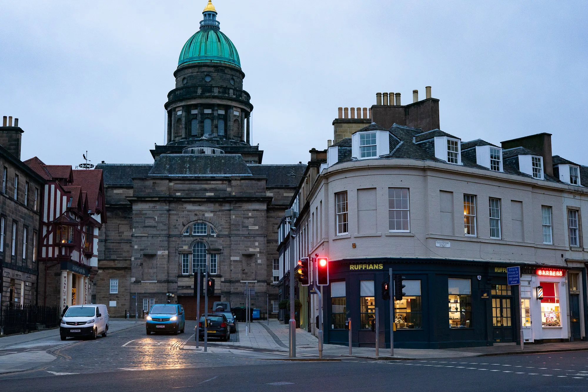 ruffians barbershop on historic edinburgh street corner at dusk