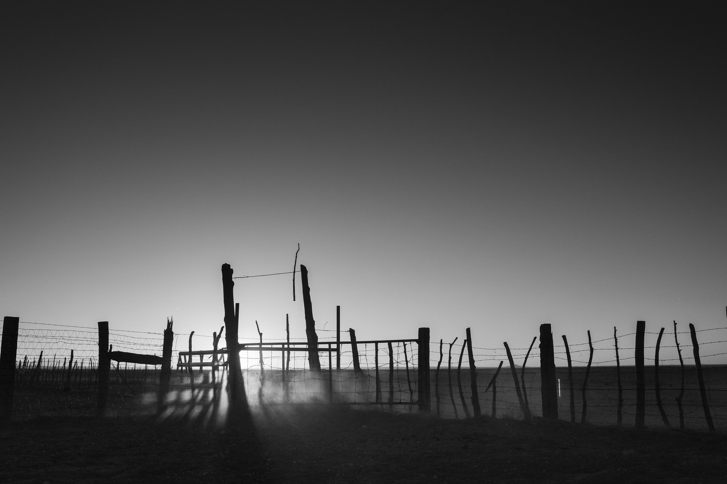 Black and white view of a ranch fence in low light on the Diamond A Ranch in Arizona