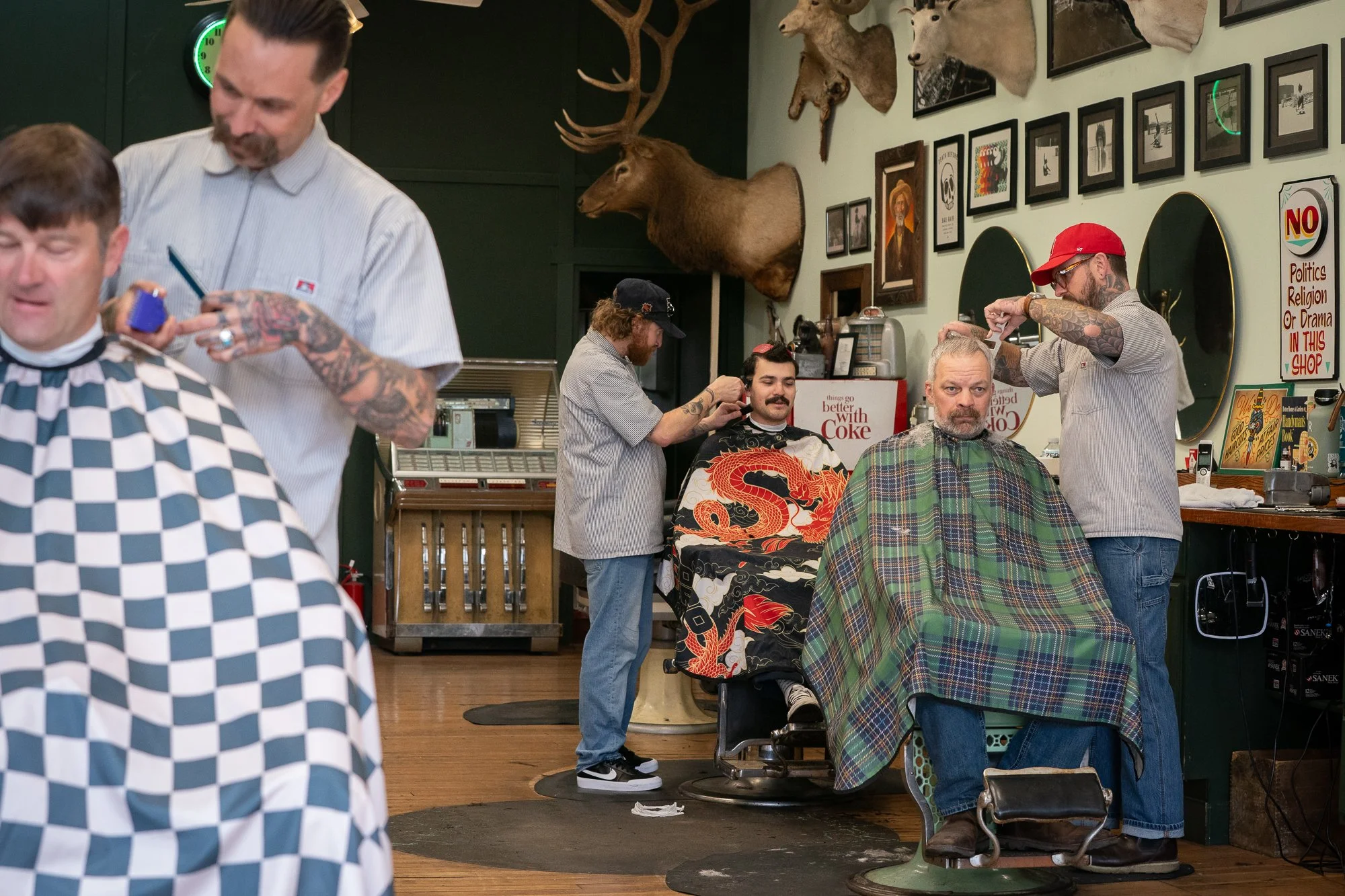 barbers cutting hair for clients inside Belmont Barbershop in Boise Idaho