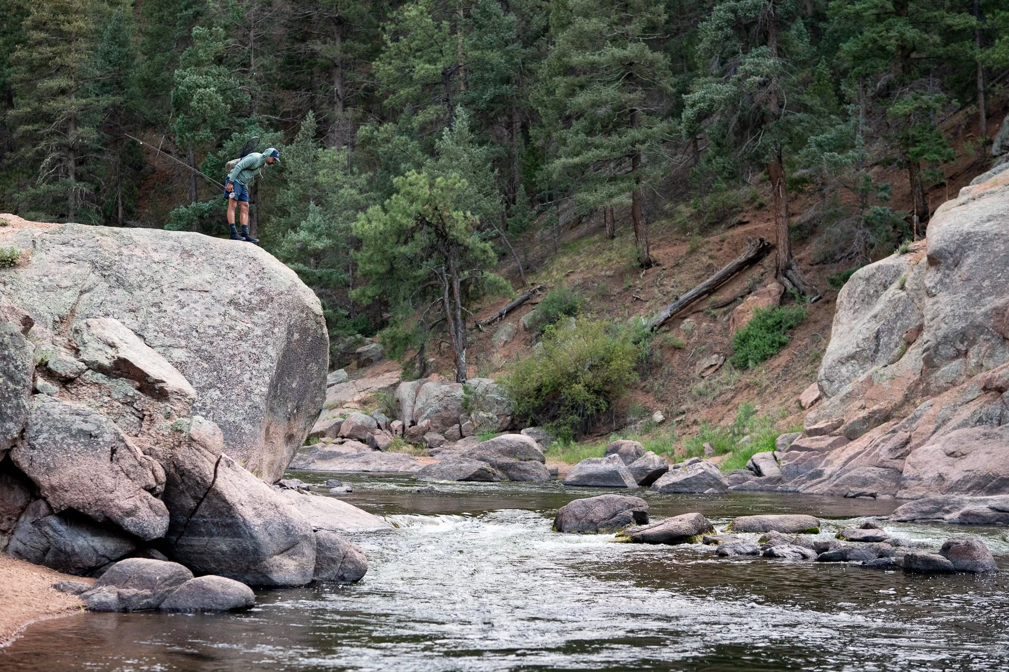 Angler standing on a large rock above the South Platte River near Deckers, Colorado