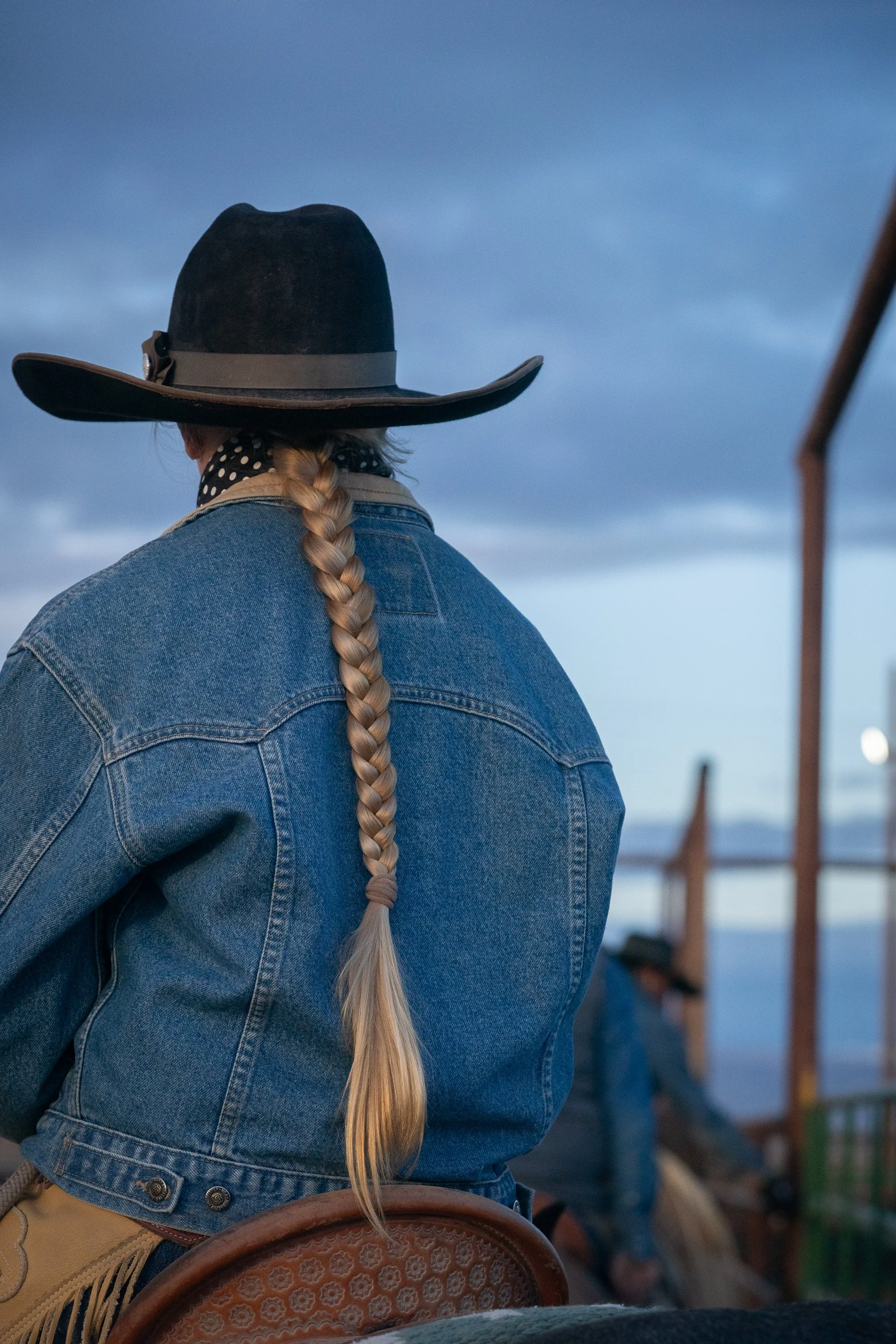 Close-up of buckaroo hair braid and hat from behind at TS Ranch